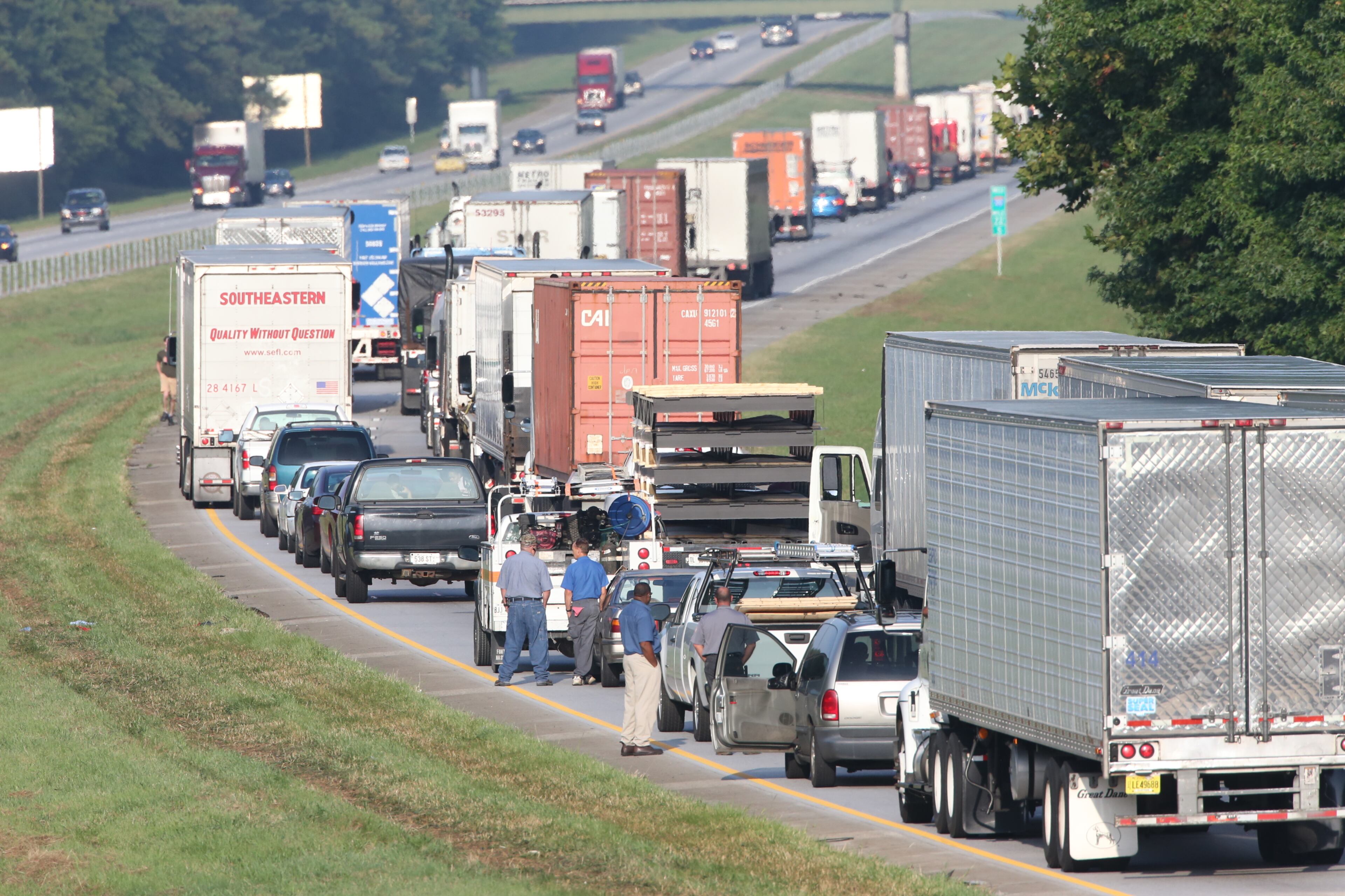 “Initial indications are that it’s a tractor-trailer and some type of bus,” the Georgia State Patrol said in an email. A FedEx truck with tandem trailers was overturned on the right side of the roadway, and the bus overturned and caught fire along the wood line. JOHN SPINK/JSPINK@AJC.COM