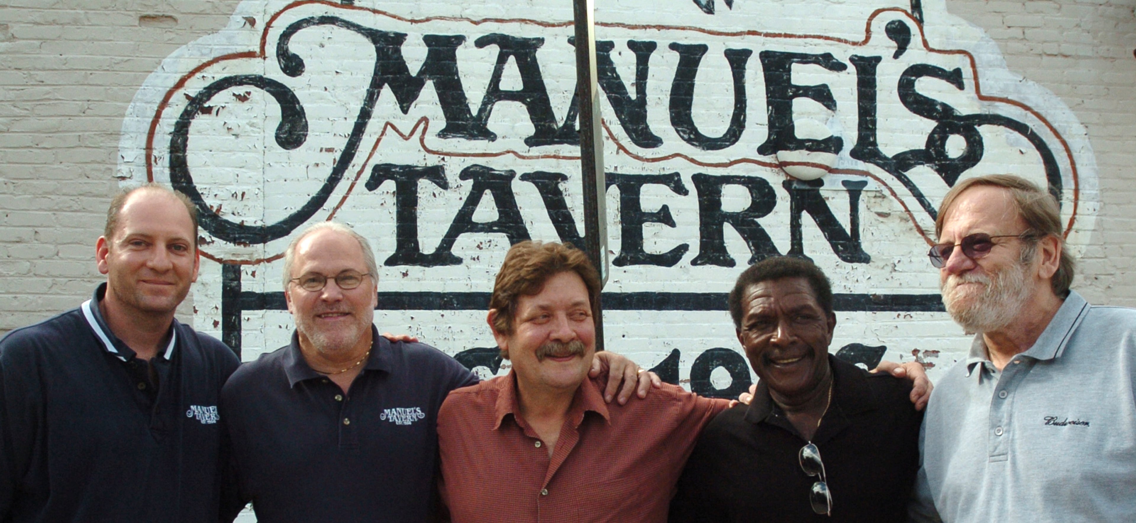 Manuel Maloof's son Brian Maloof (from left), and workers Bobby Agee (30-year-employee), Pat Glass (30-year-employee), Curtis McBride (39-year-employee) and Bill McCloskey (34-year-employee) outside of Manuel's Tavern on North Highland Ave. in Atlanta on July 26, 2006. (FRANK NIEMEIR/AJC staff)