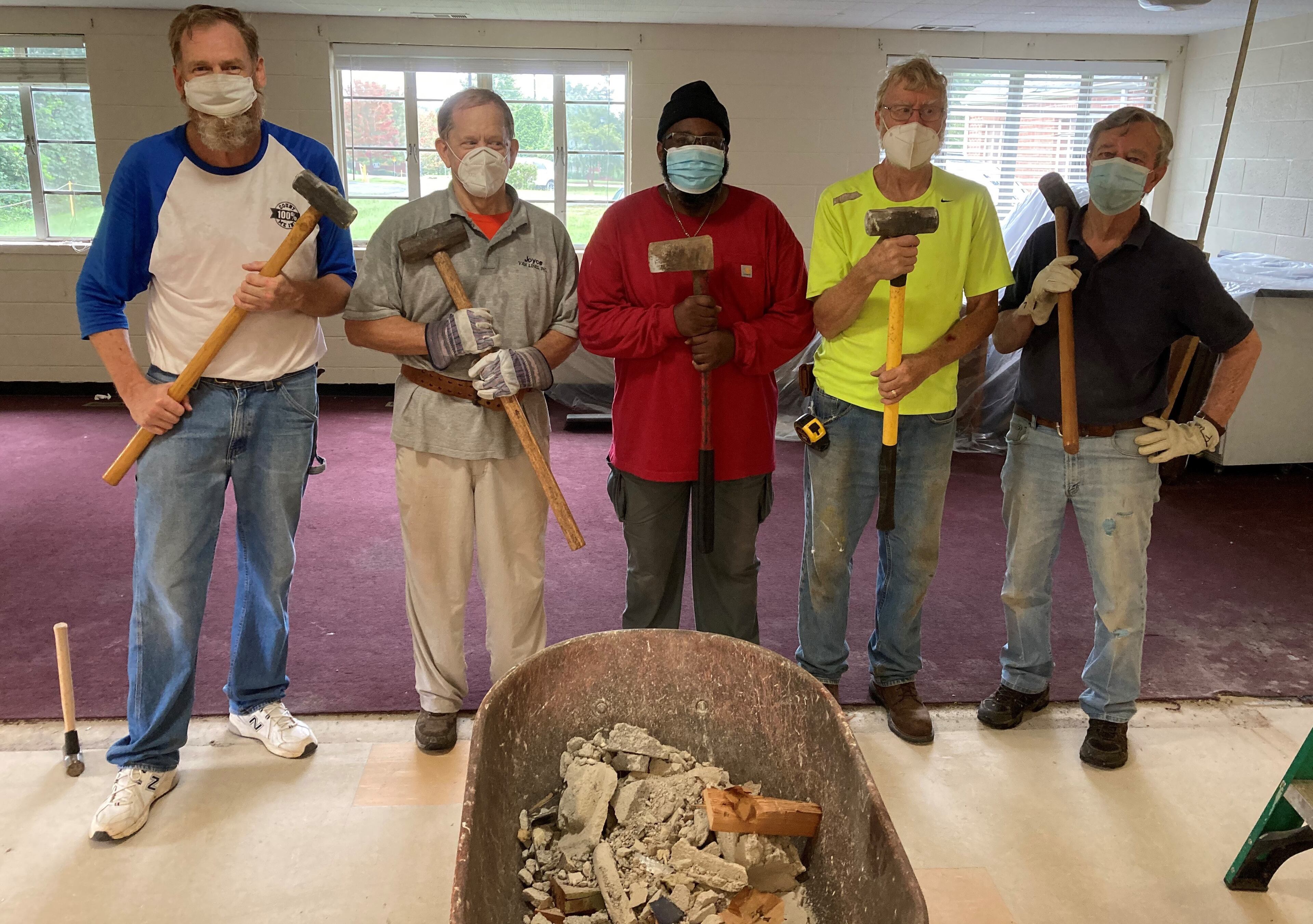 Members of Saint Luke's and Dodd-Sterling pose after tearing down a wall at the Southside church. (Courtesy of Daryl Moore)