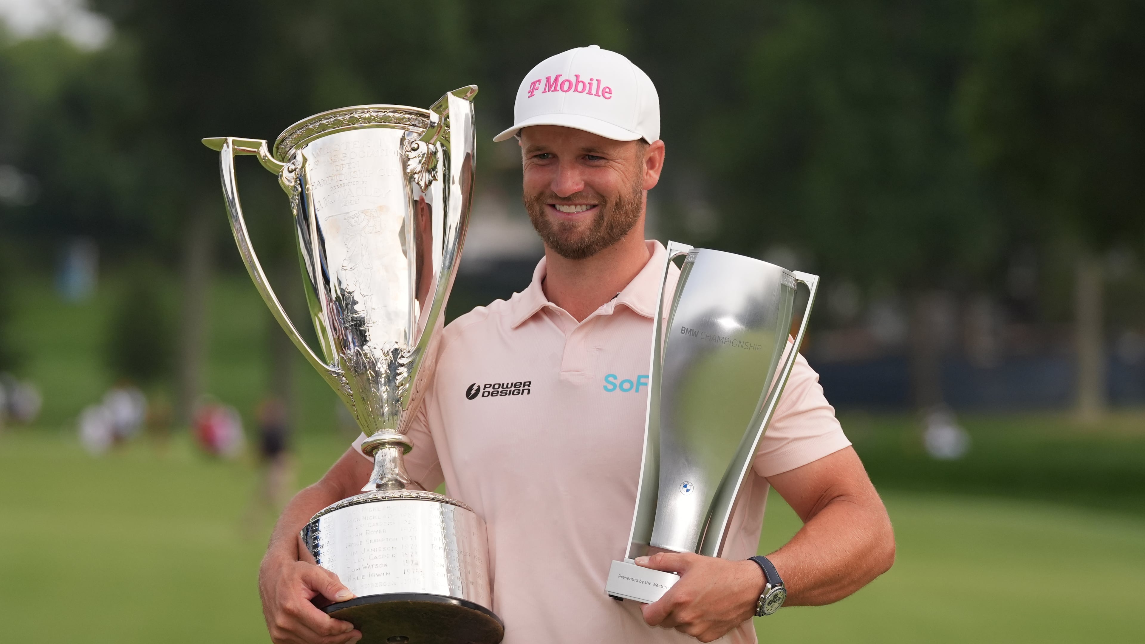 Wyndham Clark holds the Wanamaker Trophy and the BMW trohy after winning the BMW Championship golf tournament, Sunday, Aug. 23, 2026, in St. Louis. (AP Photo/Jeff Roberson)