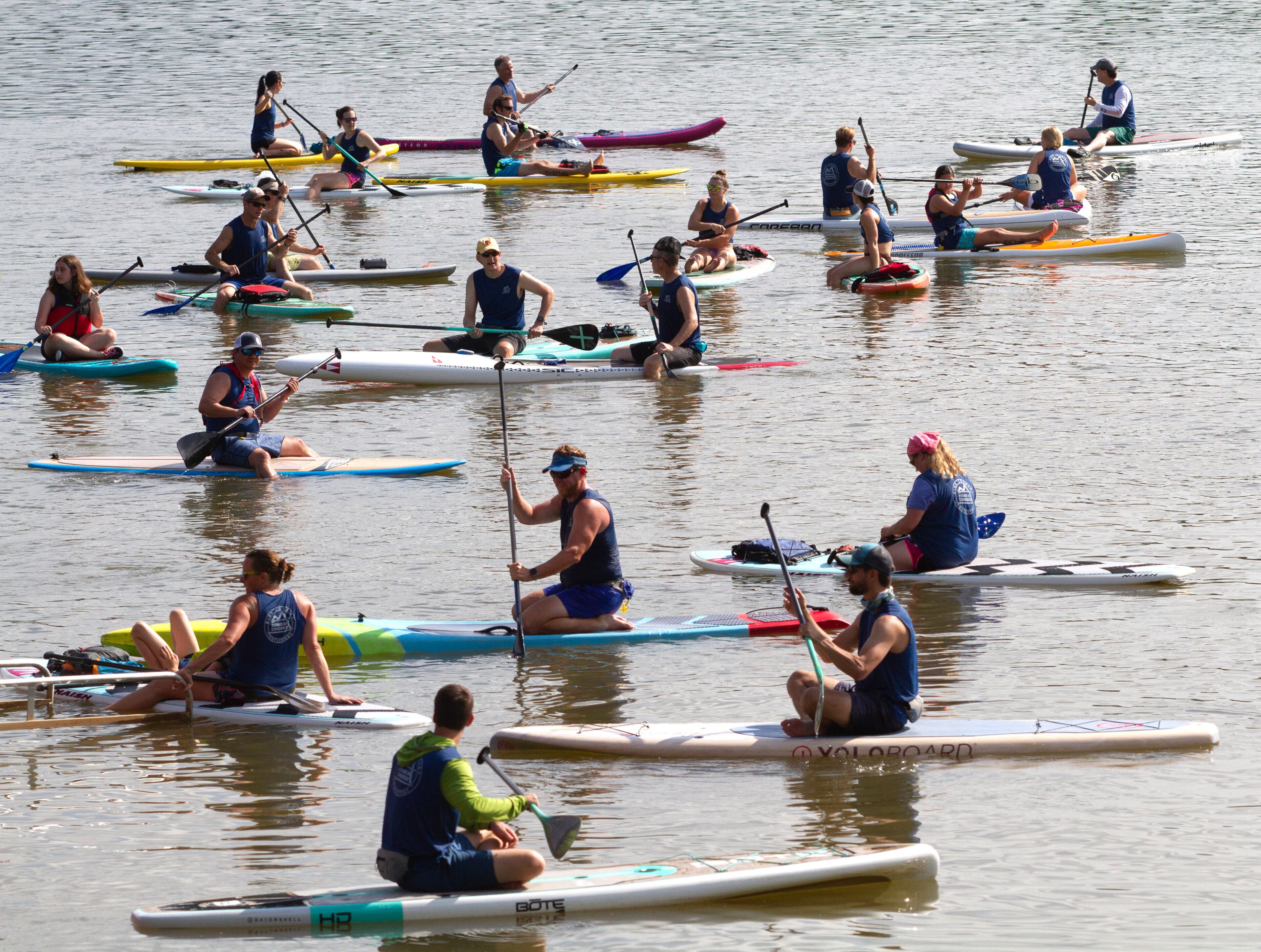 Racers cool down after crossing the finish line during the 8th annual Stand Up for the Hooch at Morgan Falls Overlook Park in Sandy Springs on Sunday, June 23, 2019. This years race included several different types of watercraft including Surfski, Outrigger Canoes, and Kayaks. STEVE SCHAEFER / SPECIAL TO THE AJC