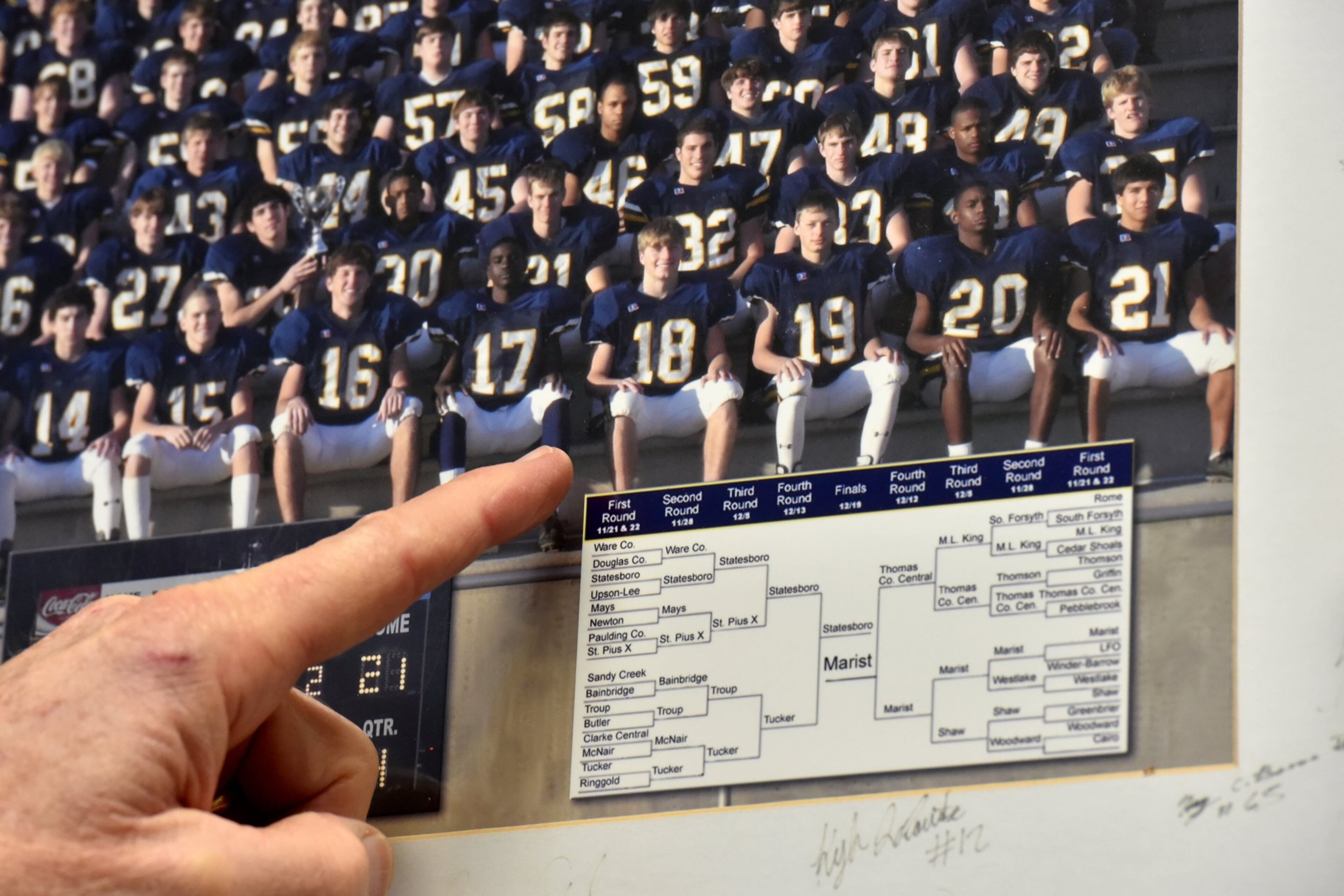 Marist High School football coach Alan Chadwick points out former Atlantan and Marist High School quarterback Sean McVay (#18) at his office. HYOSUB SHIN / HSHIN@AJC.COM
