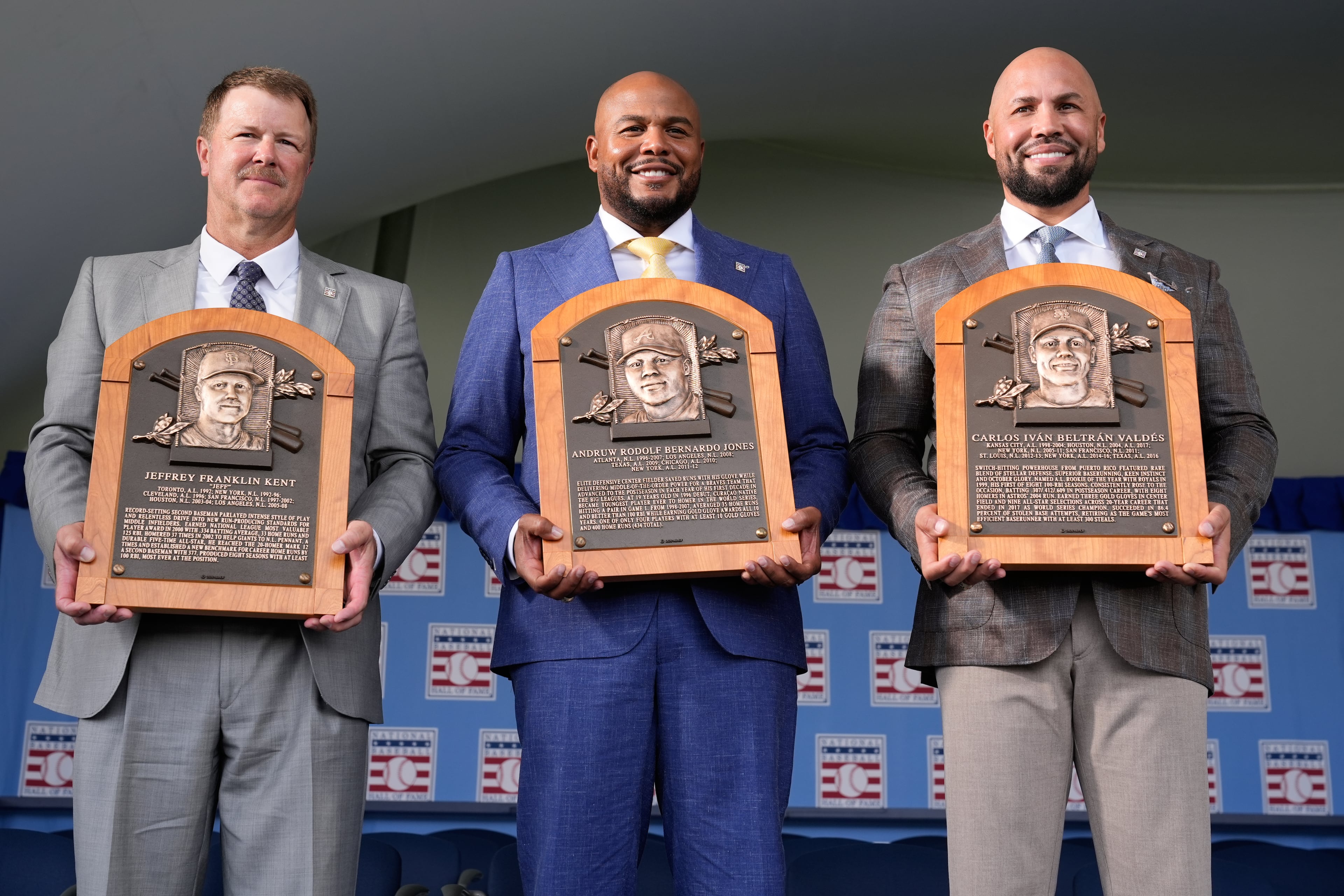 Inductees (from left) Jeff Kent, Andruw Jones and Carlos Beltran pose for pictures after their ceremony in Cooperstown, N.Y. (Seth Wenig/AP)