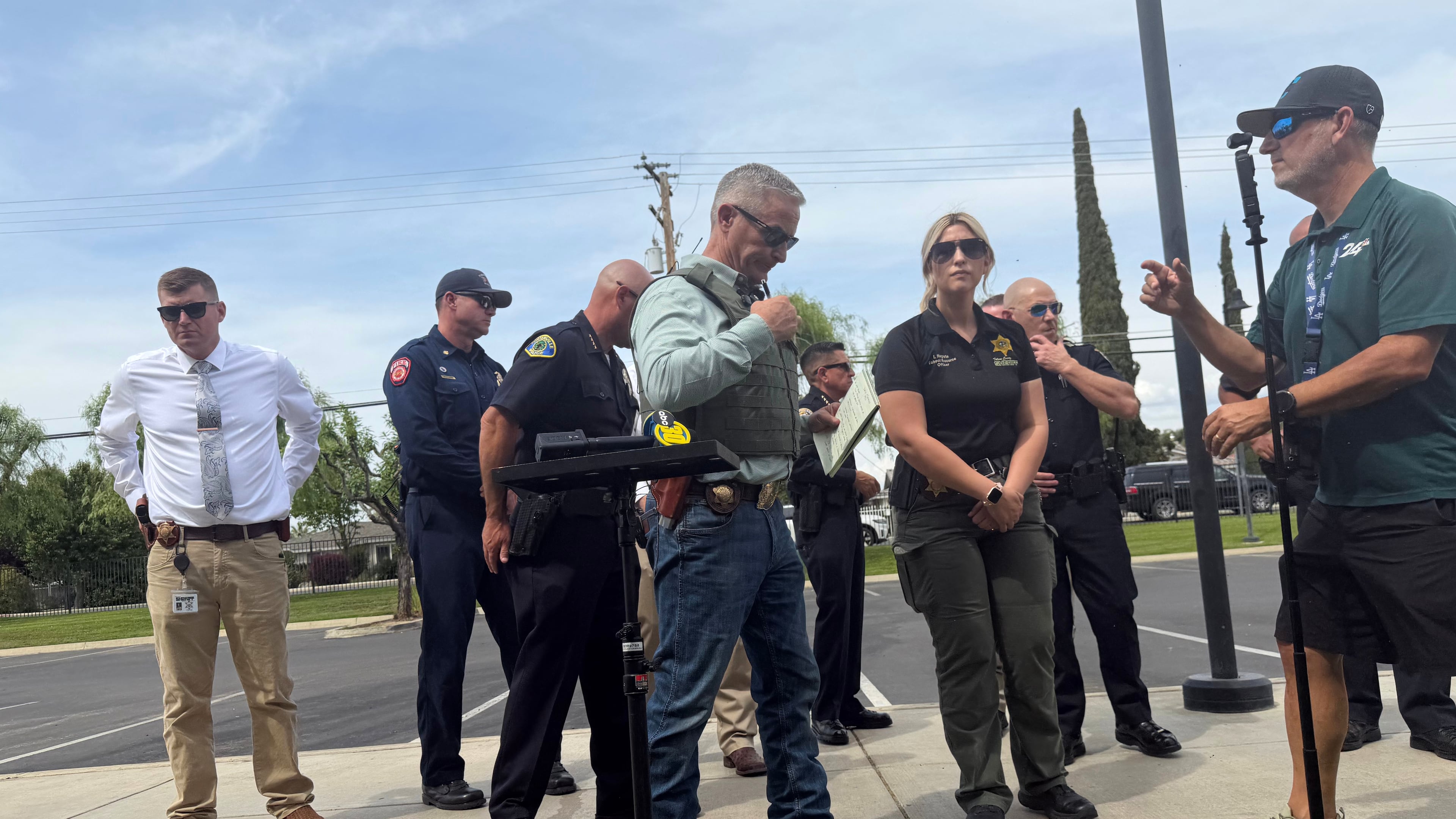 Tulare County Sheriff Mike Boudreaux, center, attends a news conference after a sheriff's deputy was shot and killed Thursday, April 9, 2026, in Porterville, Calif. (Tulare County Sheriff's Office via AP)