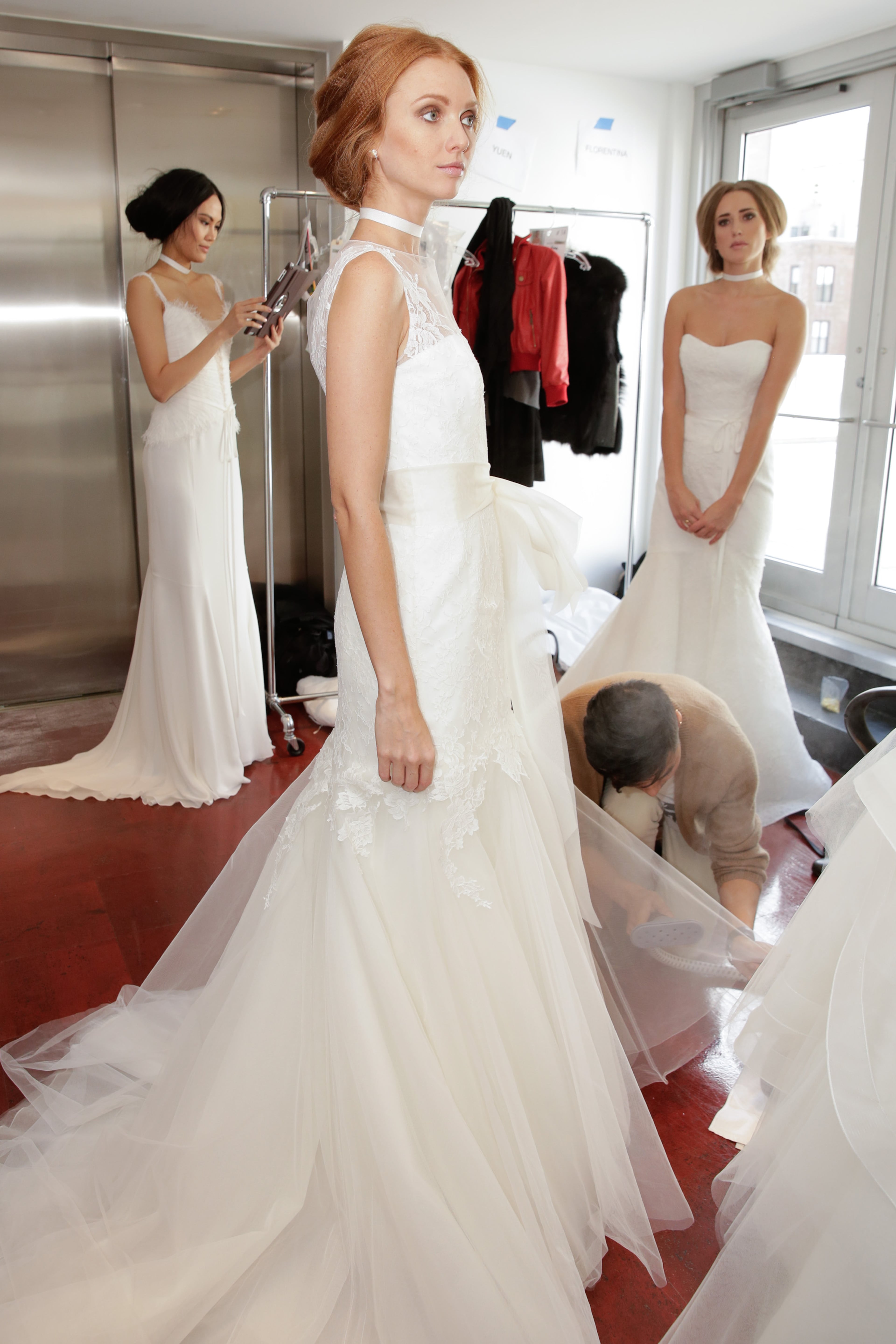 Models prepare backstage prior to the the Rita Vinieris-Rivini Fall 2014 Bridal Collection at Alvin Alley Studios on Oct. 13, 2013, in New York City.