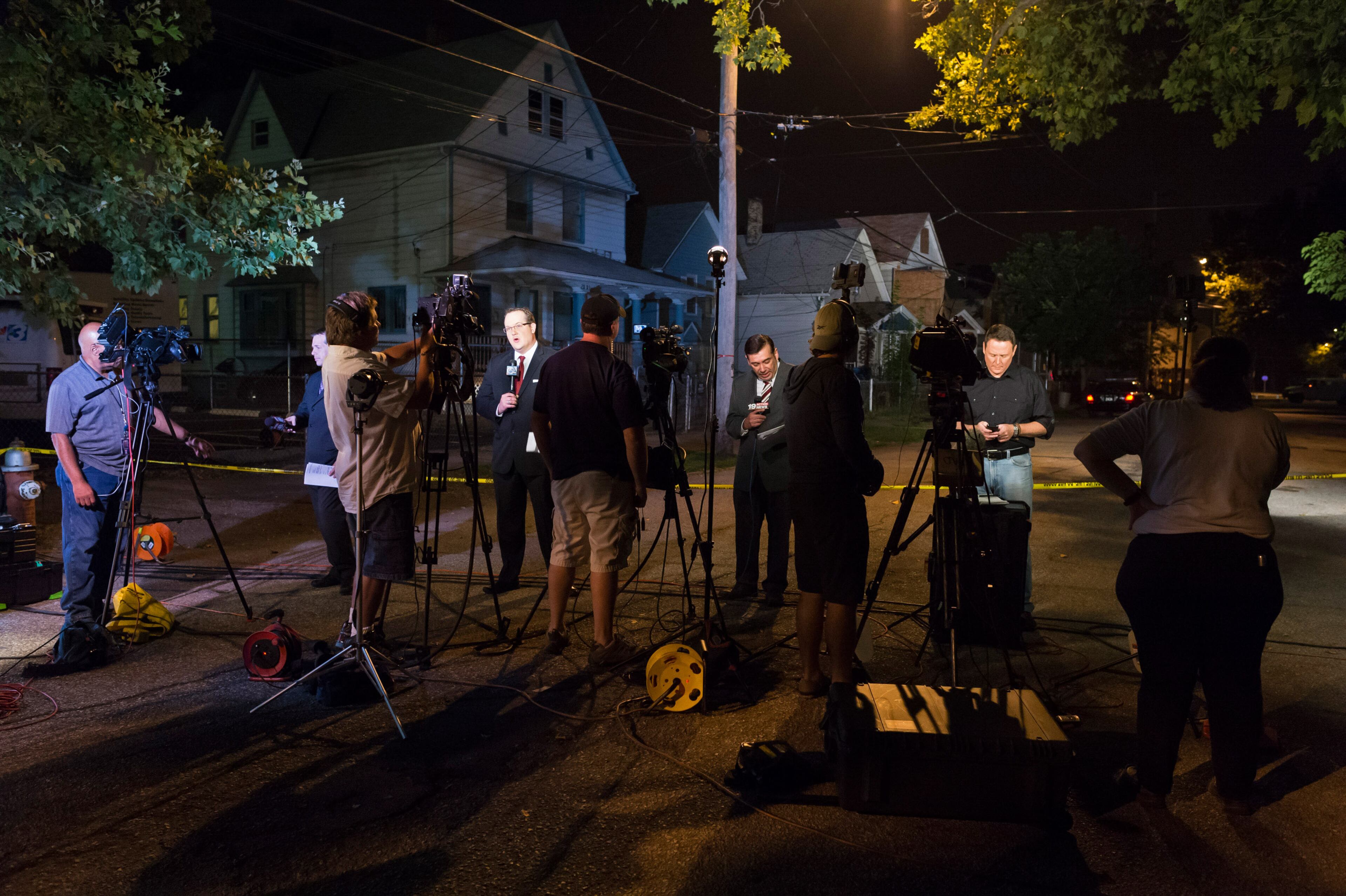 Reporters and television crews gather outside the home of Ariel Castro before its demolition on Aug. 7, 2013, in Cleveland, Ohio. Castro was found guilty of abducting three women from 2002 to 2004 and holding them captive in his home on Seymour Street. He was sentenced to life in prison with no parole plus 1,000 years.
