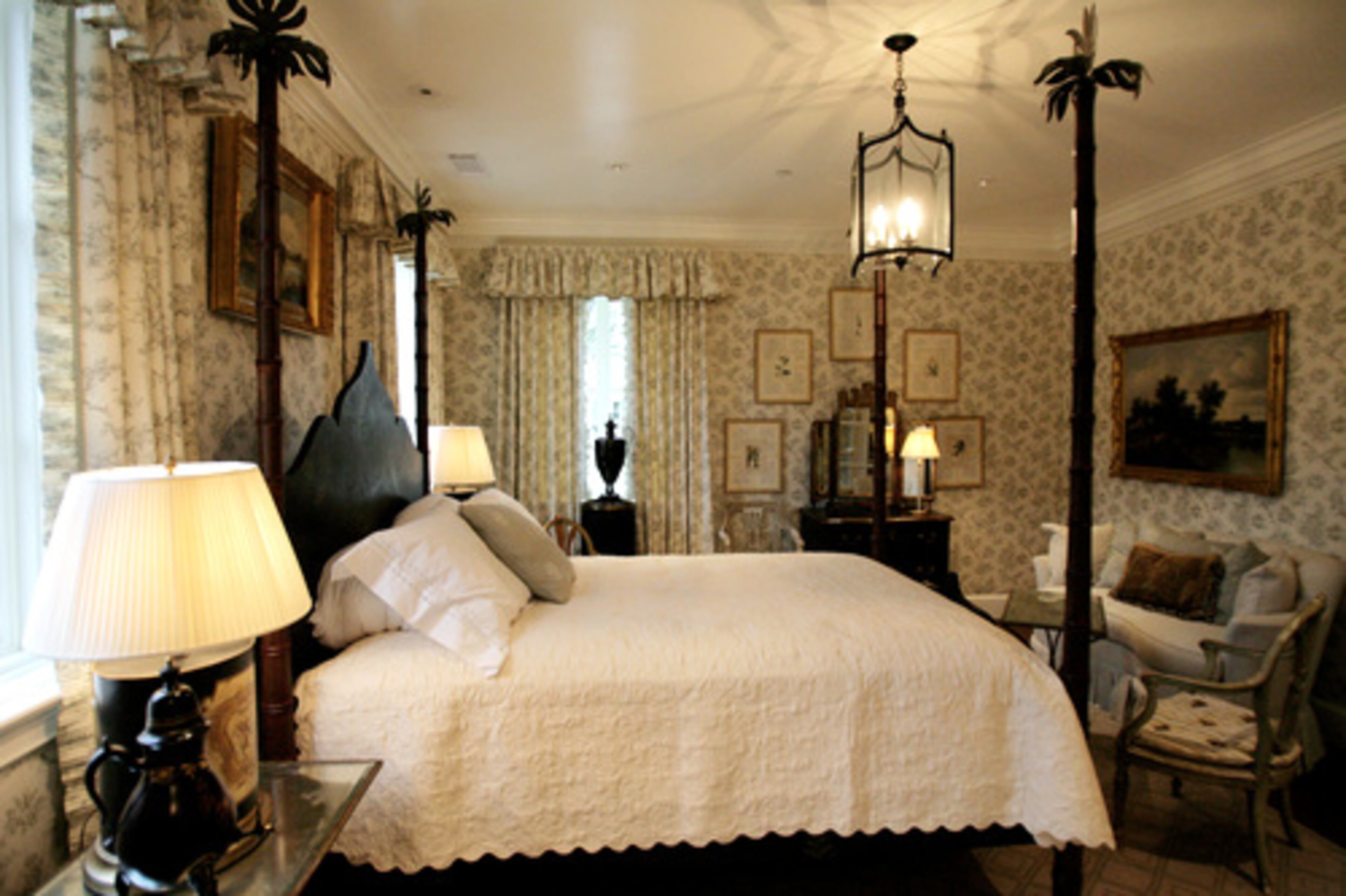 With faux-bamboo posts on the Patina Inc. bed, the second guest room has a tropical feel. Carithers uses a green-gray Chelsea Editions fabric on the walls and drapes.