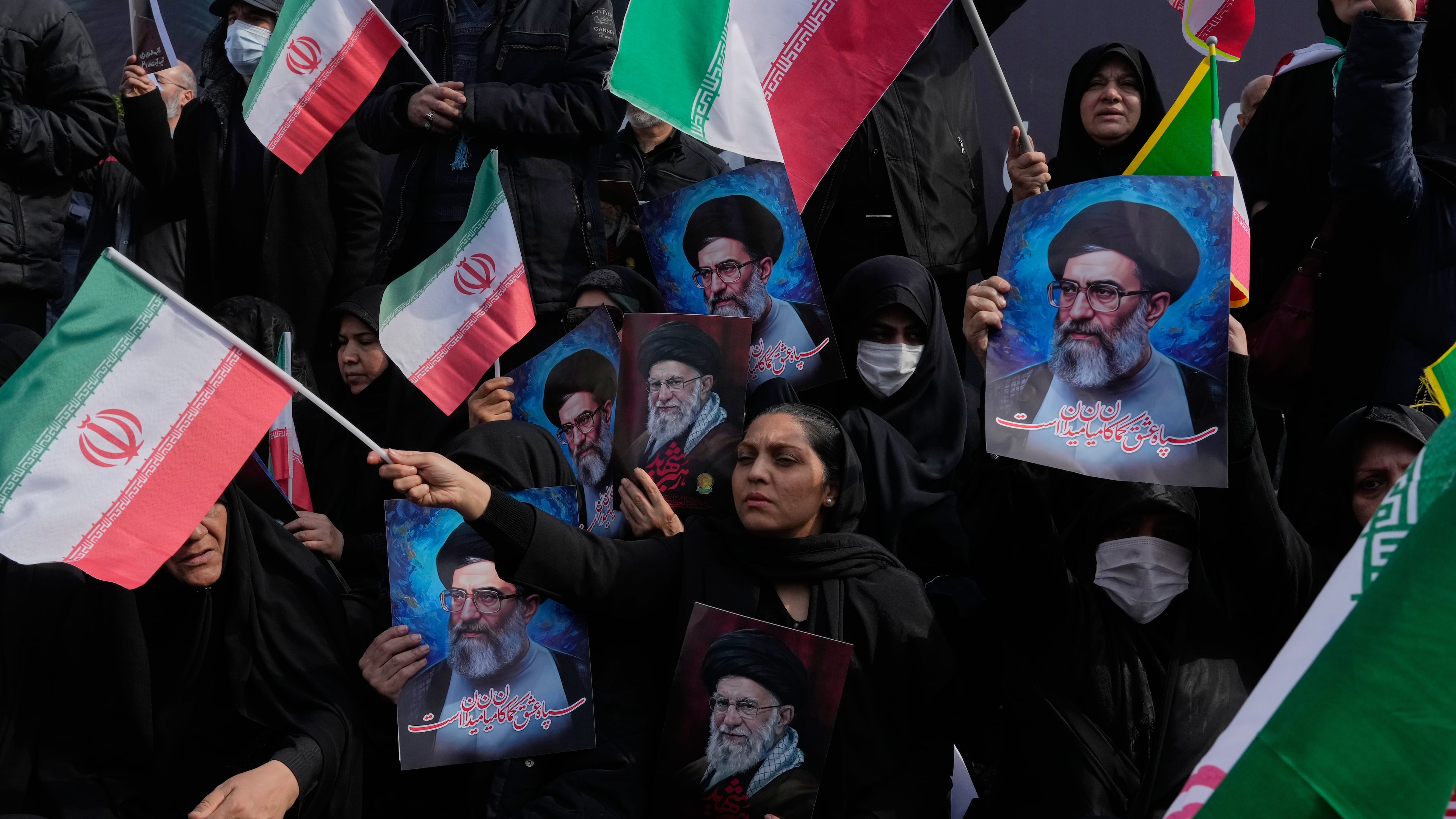 People wave Iranian flags as they hold posters of the late Supreme Leader Ayatollah Ali Khamenei, showing him at different ages, during a rally to support his son Ayatollah Mojtaba Khamenei, who succeeds his father as the new supreme leader, in Tehran, Iran, Monday, March 9, 2026. (AP Photo/Vahid Salemi)