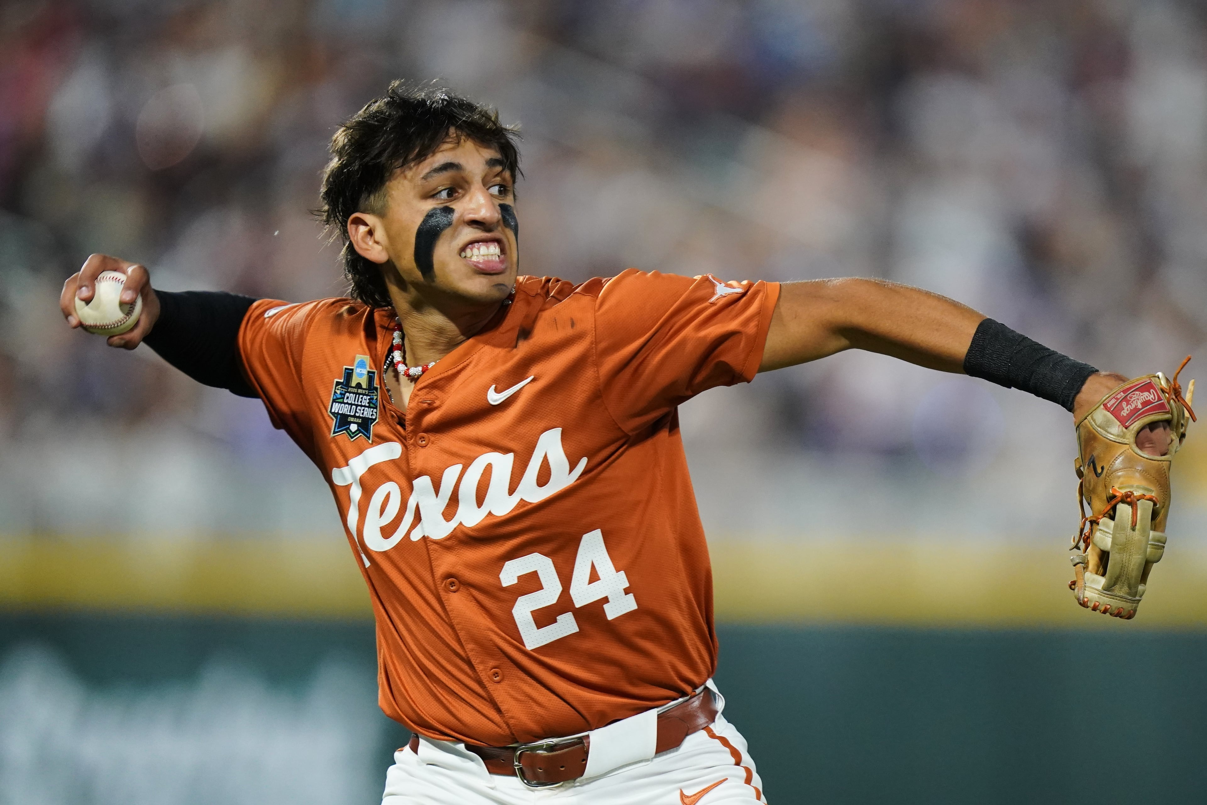Texas infielder Adrian Rodriguez (24) throws to the infield after making the catch during an NCAA baseball College World Series elimination game against Georgia, Tuesday, June 16, 2026 in Omaha, Neb. Georgia won 2-0. (AP Photo/Vera Nieuwenhuis)
