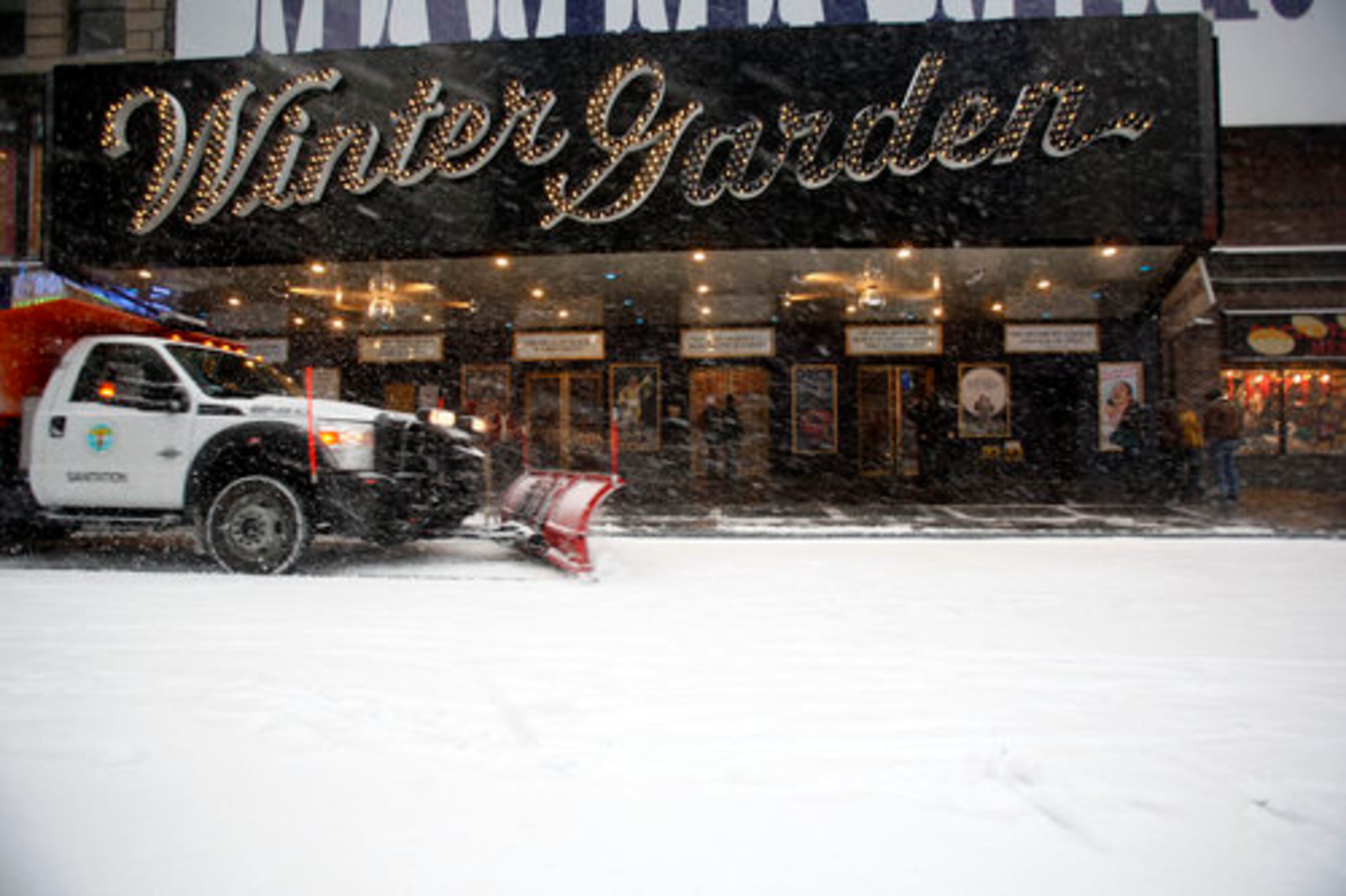 A snow plow clears snow off Broadway in front of the Winter Garden theater during a blowing snowstorm, Sunday, Dec. 26, 2010 in New York's Times Square.