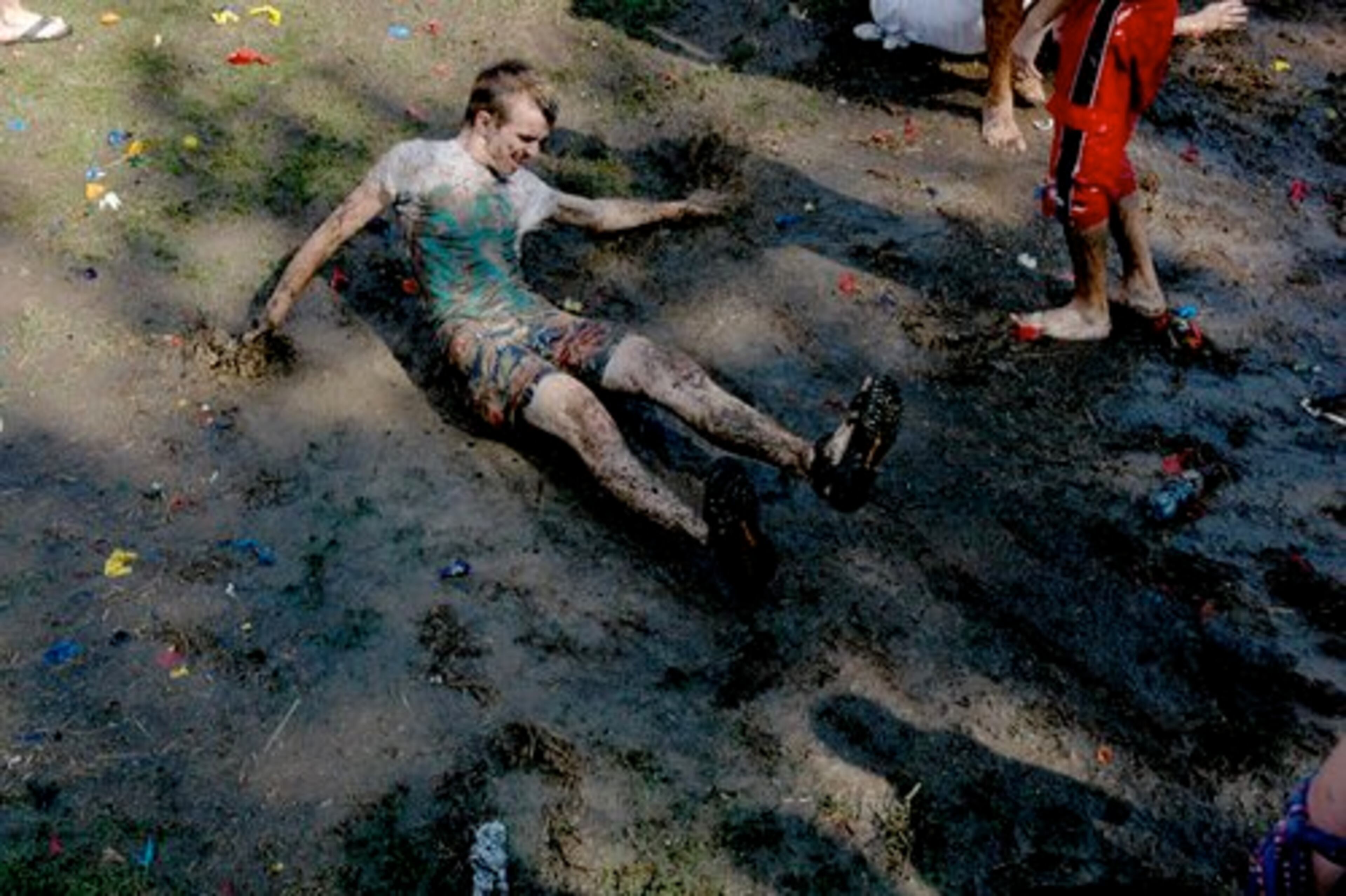 John Fink, 17, of Cumming, took advantage to the mud pit that formed afterward for a fun slide.