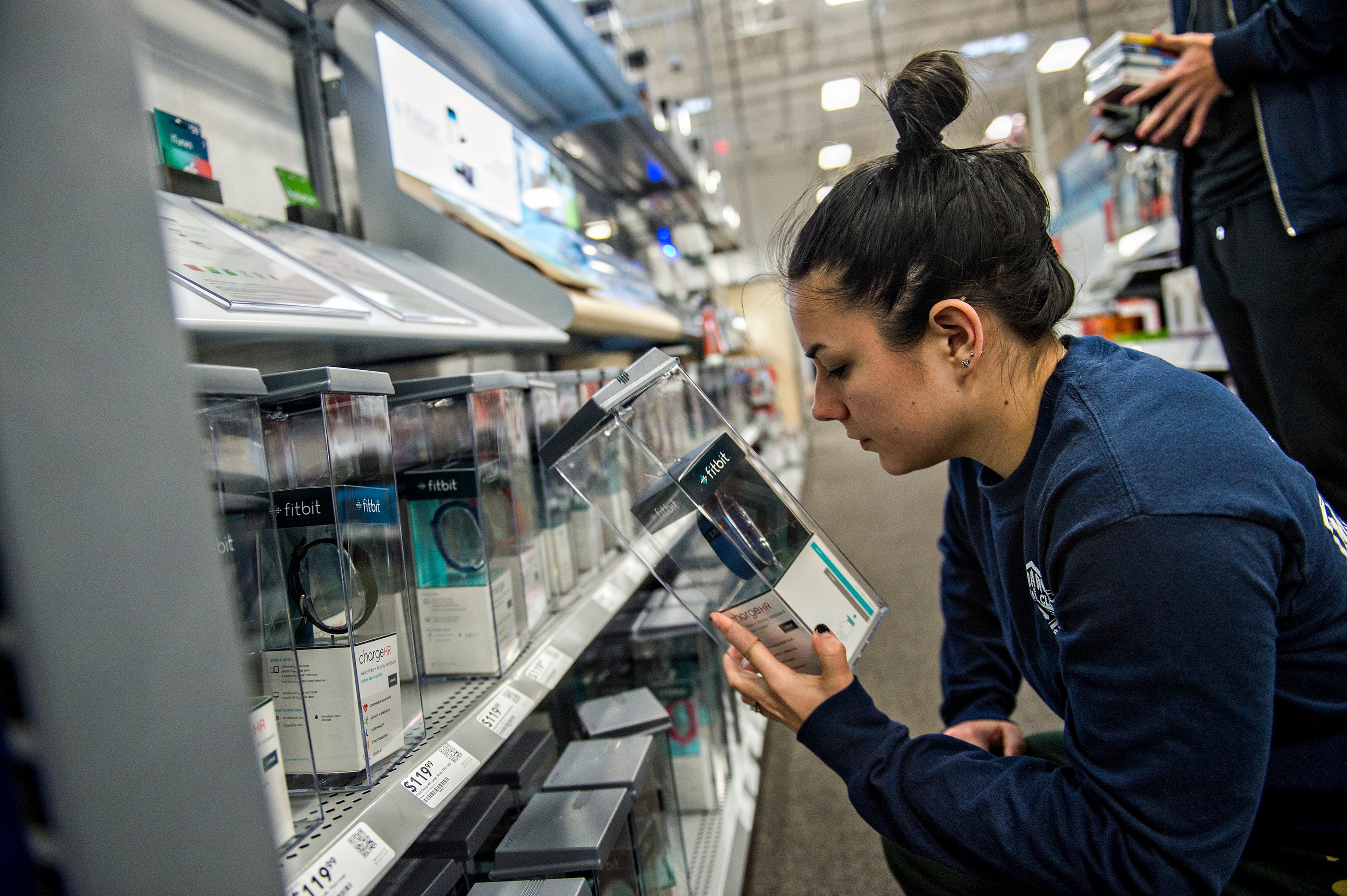 Michele Thaxton looks at a Fitbit inside Best Buy Perimeter in Atlanta during Gray Thursday on Thanksgiving night, Thursday, November 26, 2015. Hundreds of people came out for the start of the biggest shopping weekend of the year. JONATHAN PHILLIPS / SPECIAL