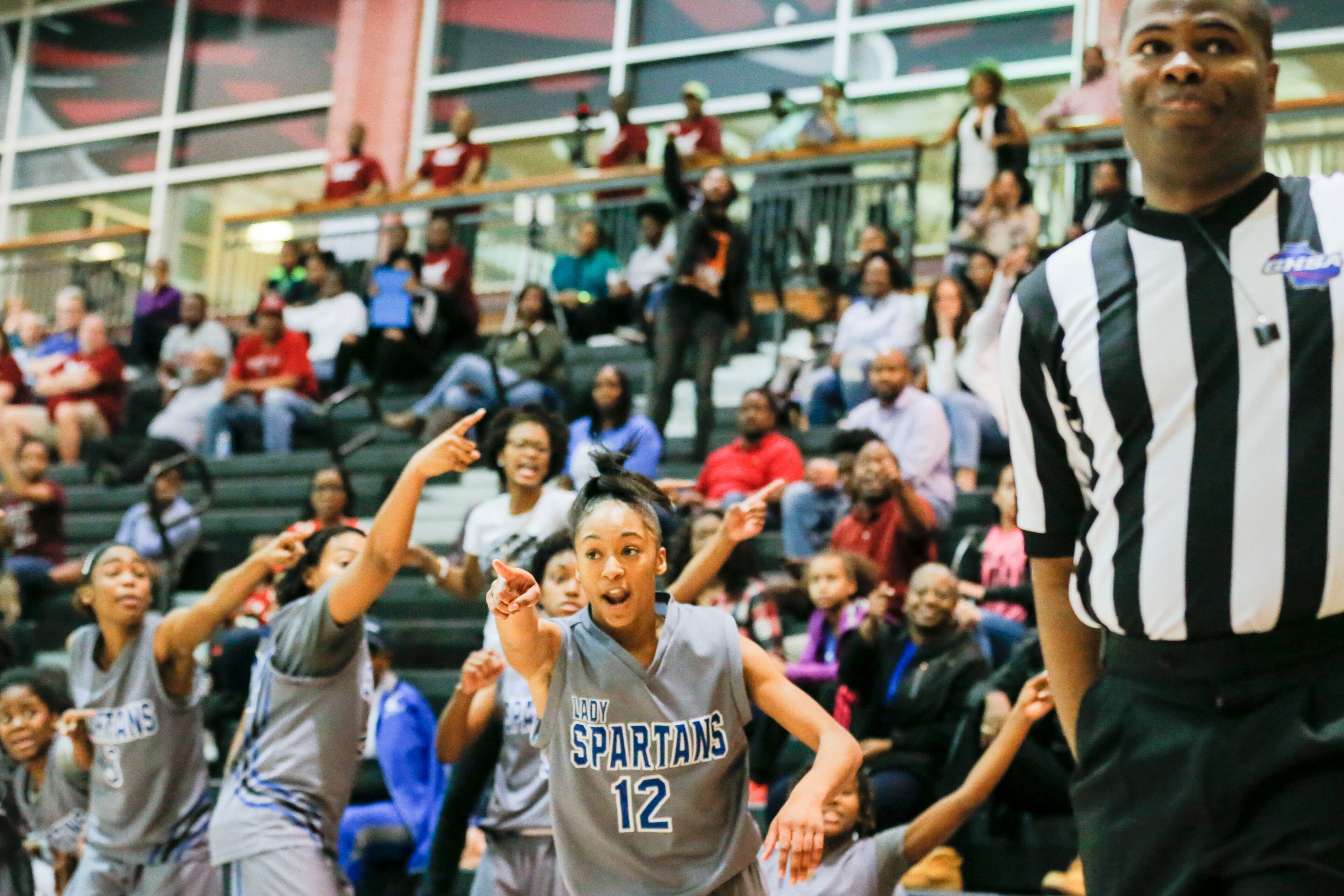 02/21/2018 -- Powder Springs, GA - The Lady Spartans' Jada Alston (12) signals to the referee that a loose ball was last touched by the Lady Hawks during the second half of the game at Hillgrove High School, Wednesday, February 21, 2018. The Campbell High School Lady Spartans lost to the Hillgrove High School Lady Hawks, 60-65. ALYSSA POINTER/ALYSSA.POINTER@AJC.COM