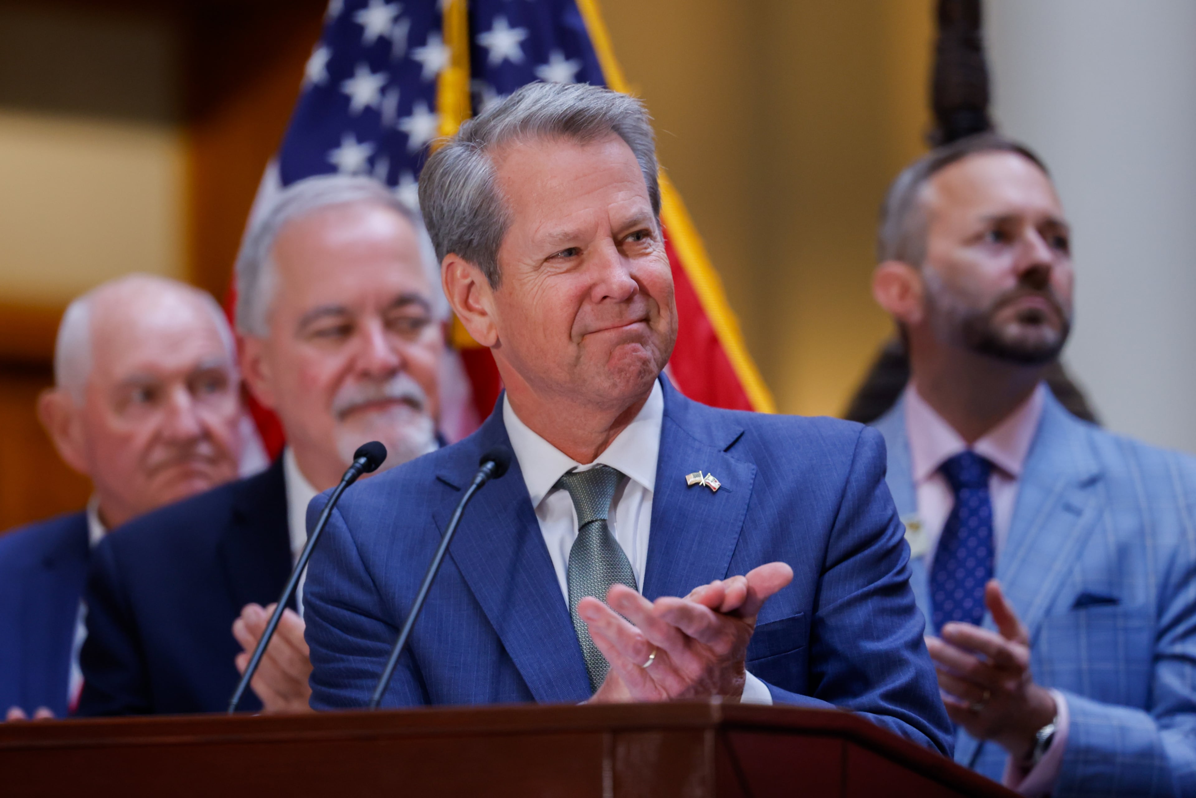 Gov. Brian Kemp claps during a speech before he signs a series of education bills at the Capitol in May, including a school literacy bill. The bills provide training and support for educators, requires screening for dyslexia and other learning disabilities and mandates kindergarten attendance. (Arvin Temkar/AJC)