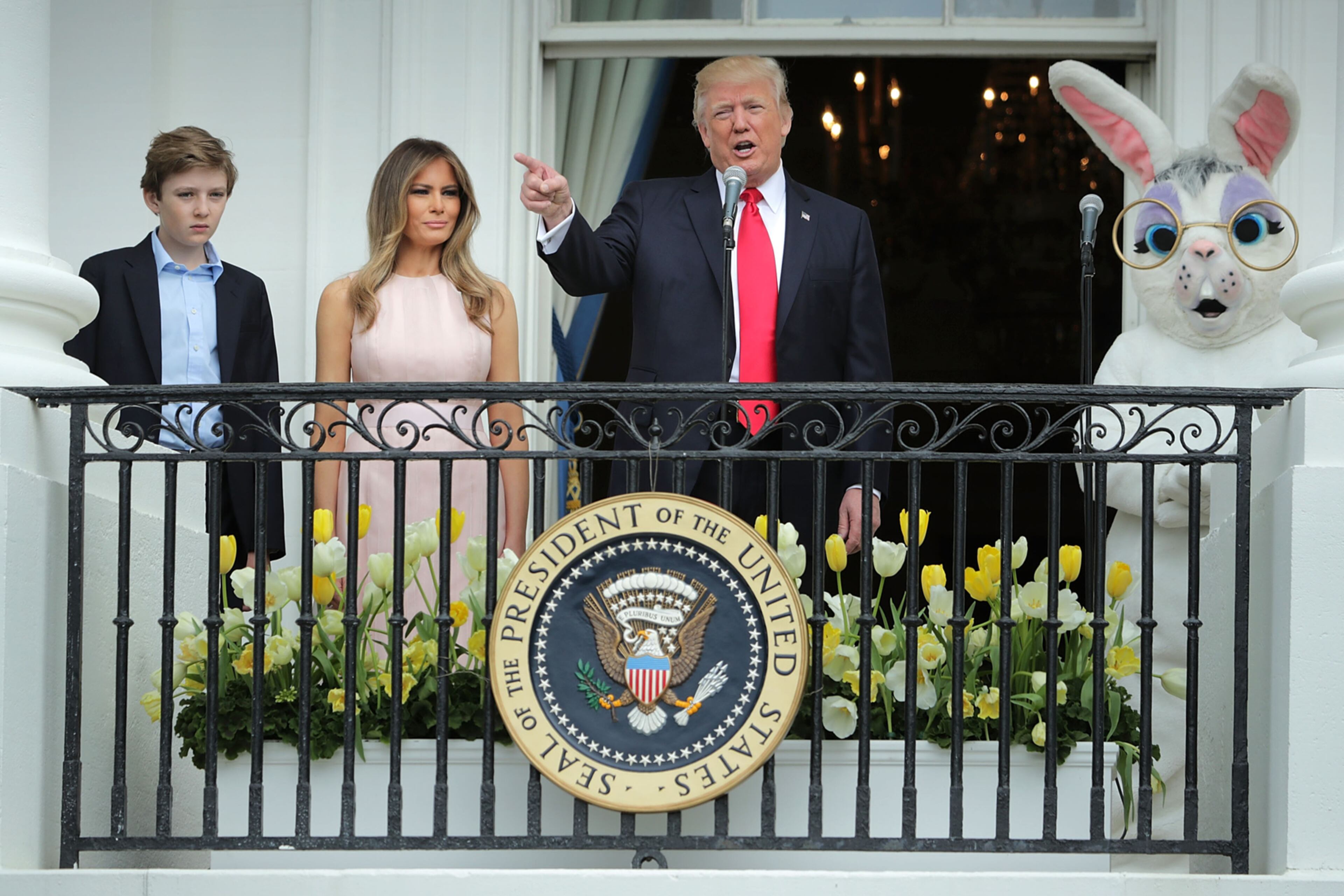 WASHINGTON, DC - APRIL 17: U.S. President Donald Trump (C) delivers remarks from the Truman Balcony with first lady Melania Trump and their son Barron Trump (L) during the 139th Easter Egg Roll on the South Lawn of the White House April 17, 2017 in Washington, DC. The White House said 21,000 people are expected to attend the annual tradition of rolling colored eggs down the White House lawn that was started by President Rutherford B. Hayes in 1878. (Photo by Chip Somodevilla/Getty Images) *** BESTPIX ***