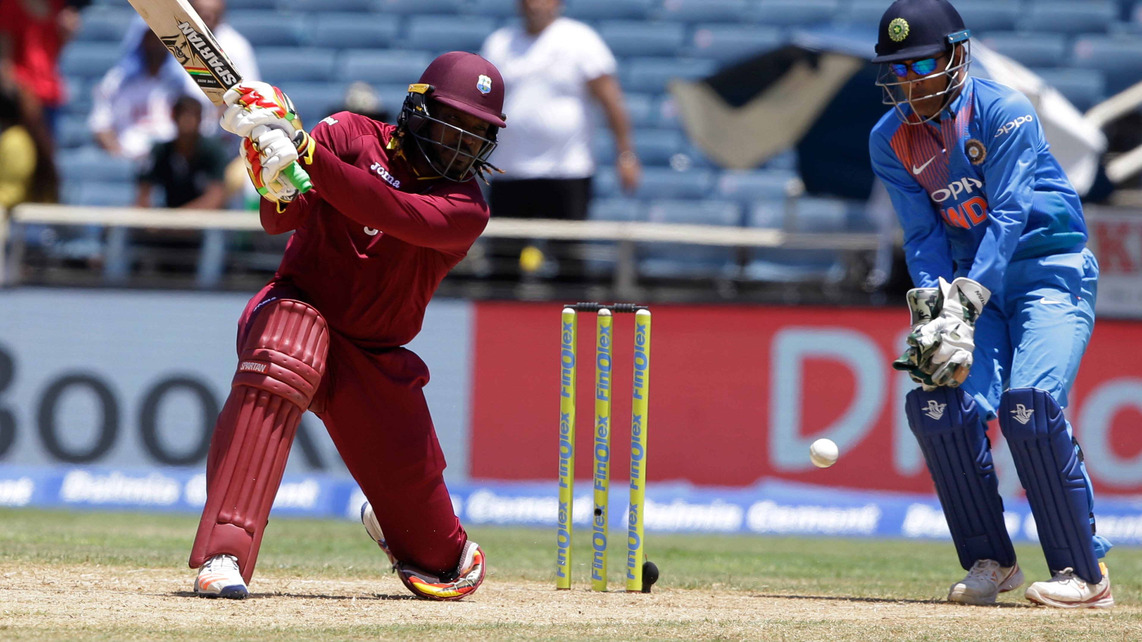 West Indies' Chris Gayle plays a shot under the watch of India's MS Dhoni during a T20I at Sabina Park cricket ground in Kingston, Jamaica, earlier this month. AP/Ricardo Mazalan