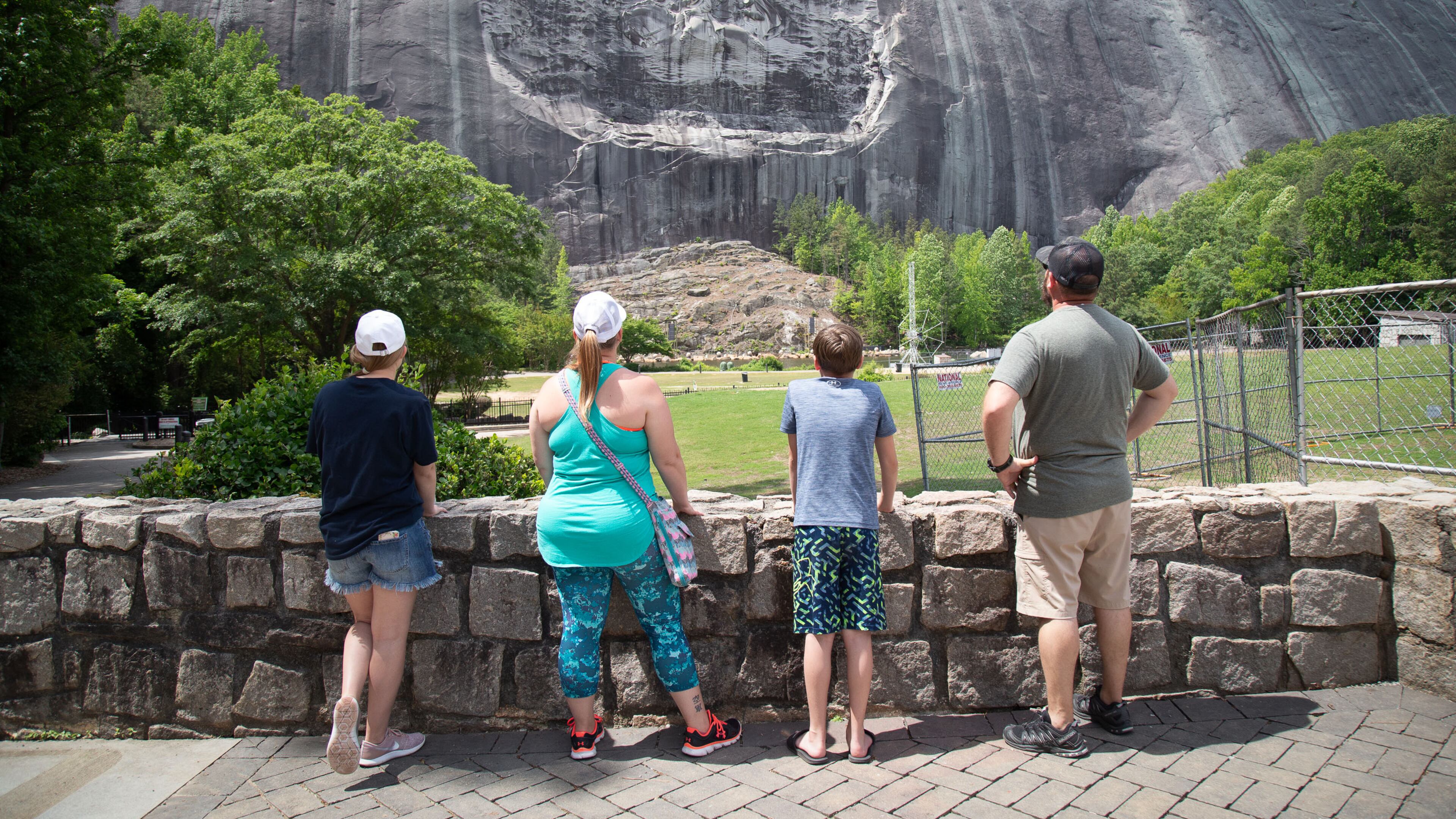 A family looks at the Confederate Memorial Carving at Stone Mountain Park Sunday, May 17, 2020. STEVE SCHAEFER FOR THE ATLANTA JOURNAL-CONSTITUTION