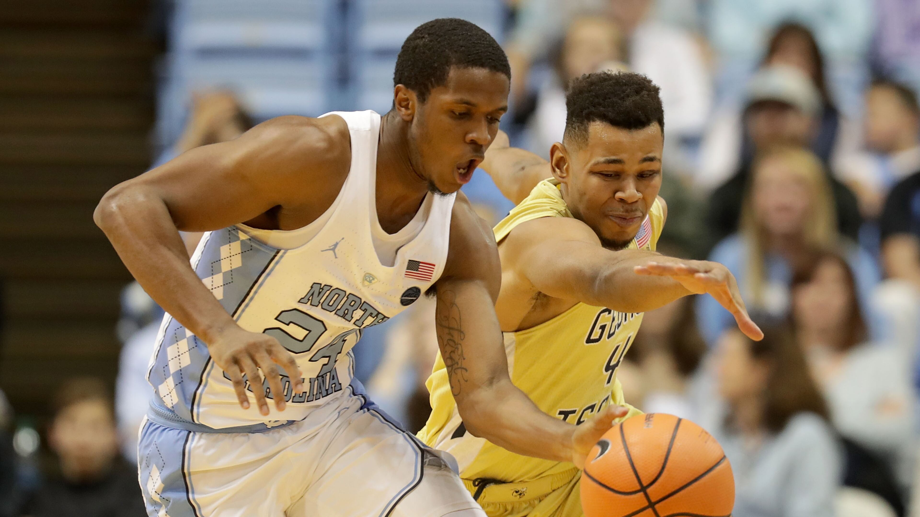 CHAPEL HILL, NC - JANUARY 20: Kenny Williams #24 of the North Carolina Tar Heels goes after a loose ball against Brandon Alston #4 of the Georgia Tech Yellow Jackets during their game at Dean Smith Center on January 20, 2018 in Chapel Hill, North Carolina. (Photo by Streeter Lecka/Getty Images)