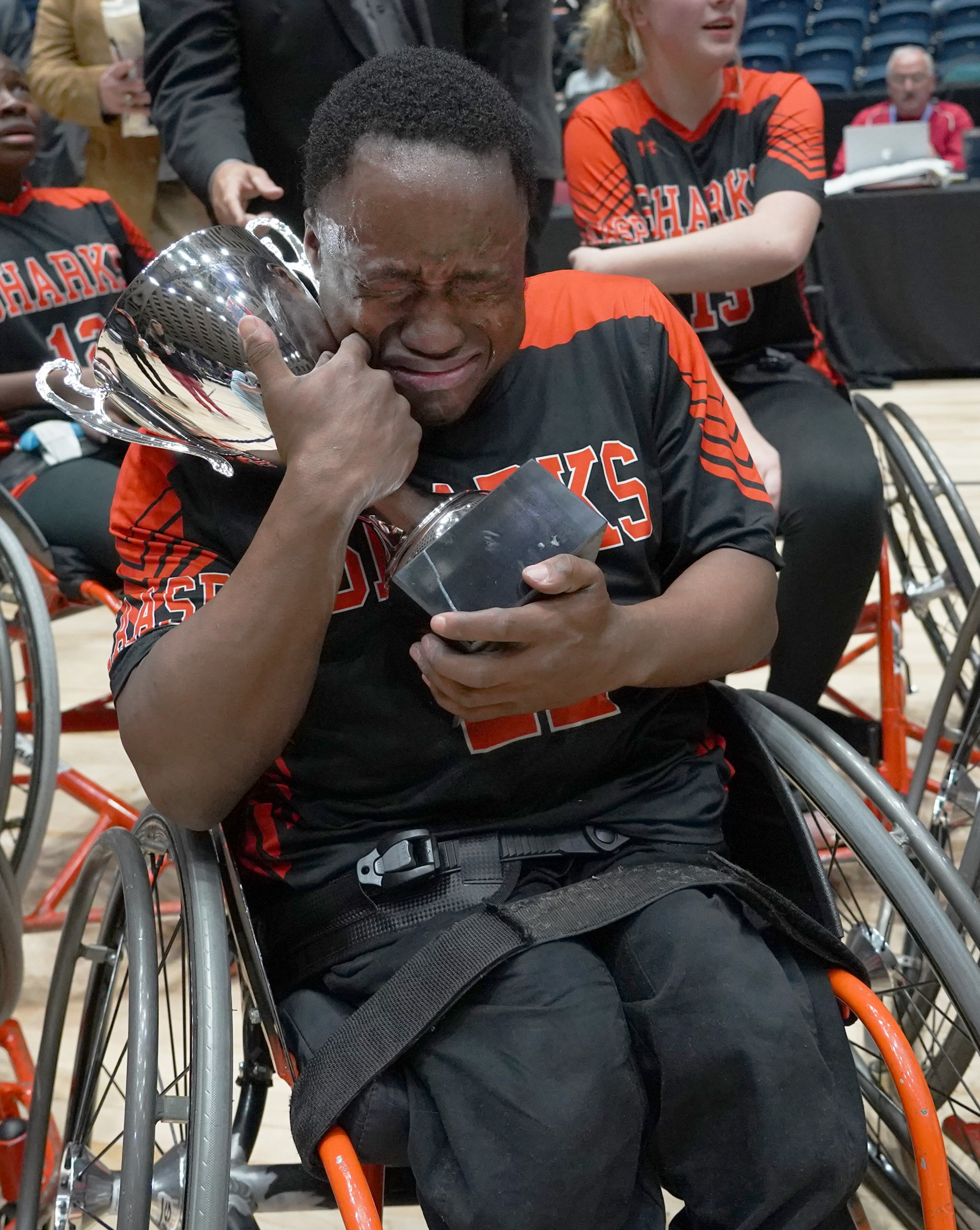 O'lando Hicks hugs the trophy after the Houston Sharks defeated the Henry Hurricanes for the GHSA wheelchair state title at the Macon Centreplex, Friday March 6, 2020, in Macon. Tami Chappell for the Atlanta Journal Constitution