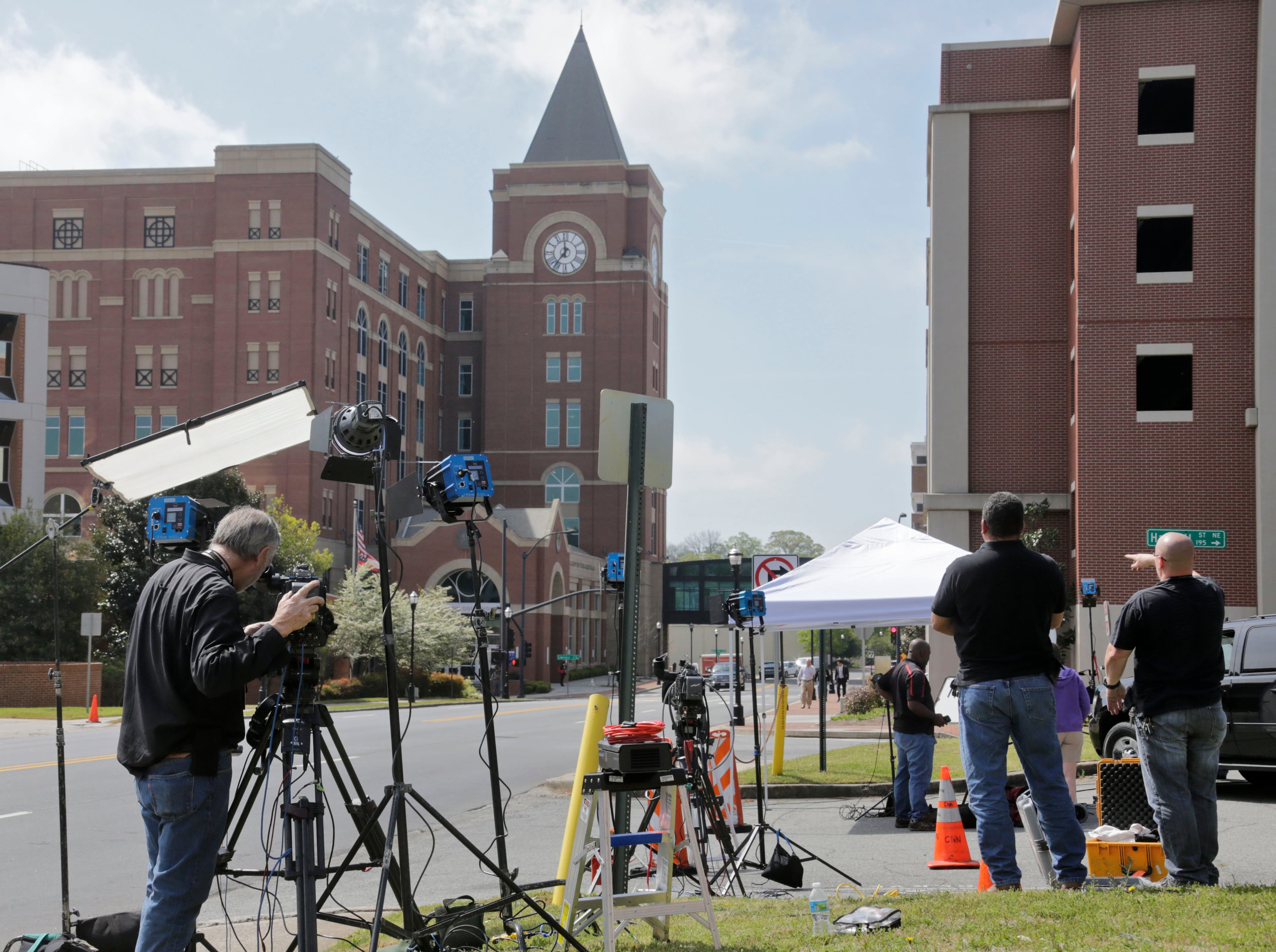 TV crews set up for live shots down the street from the Cobb County Superior Court. Justin Ross Harris murder trial begins with a parade of prospective jurors explaining to the judge why she should excuse them from service in the lengthy, sensational trial. BOB ANDRES / BANDRES@AJC.COM