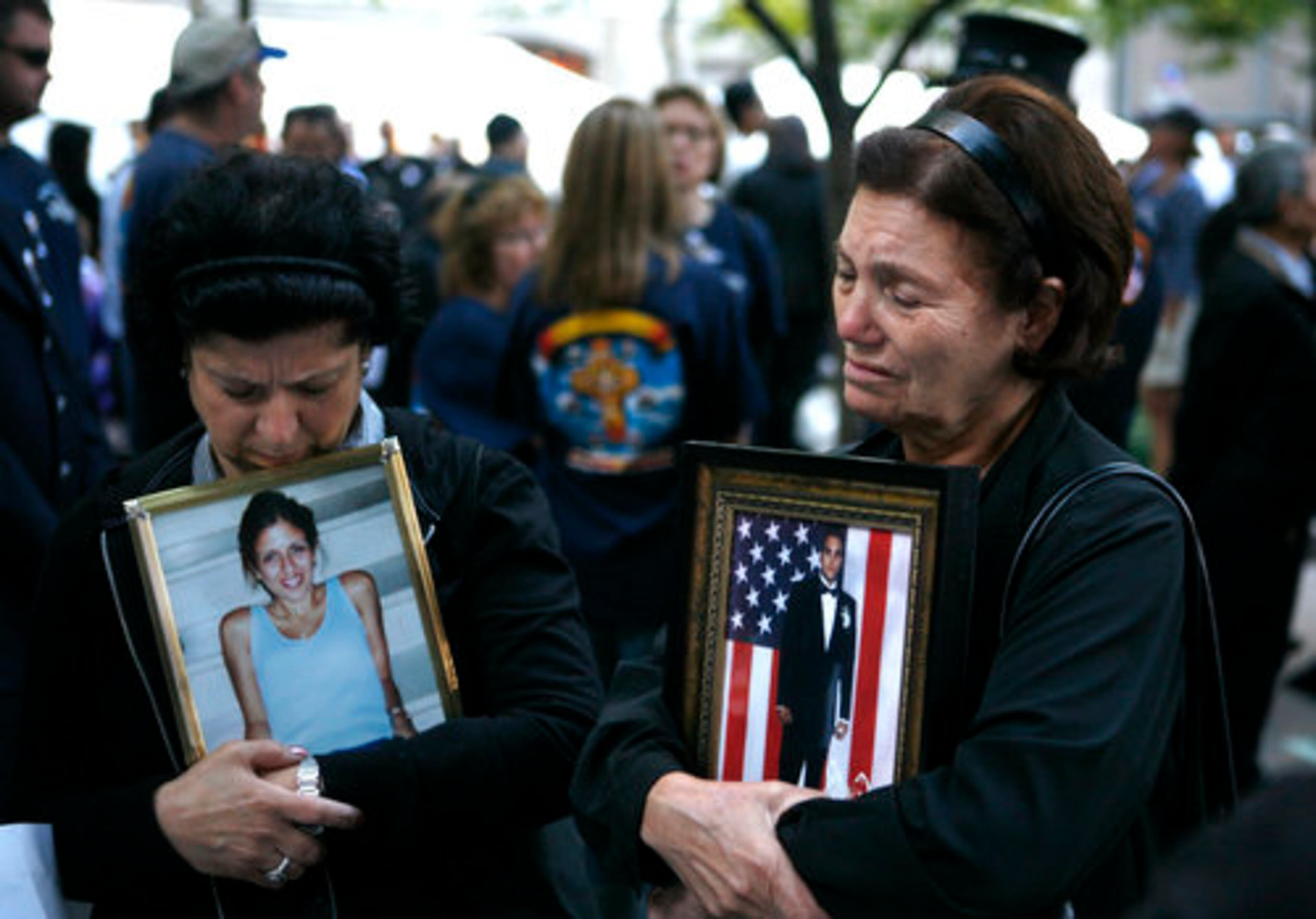 Rosa Notaro and Anna Sereno, both from Brooklyn, hold photos of their children, Daniella Notaro and Arturo Angelo Sereno.