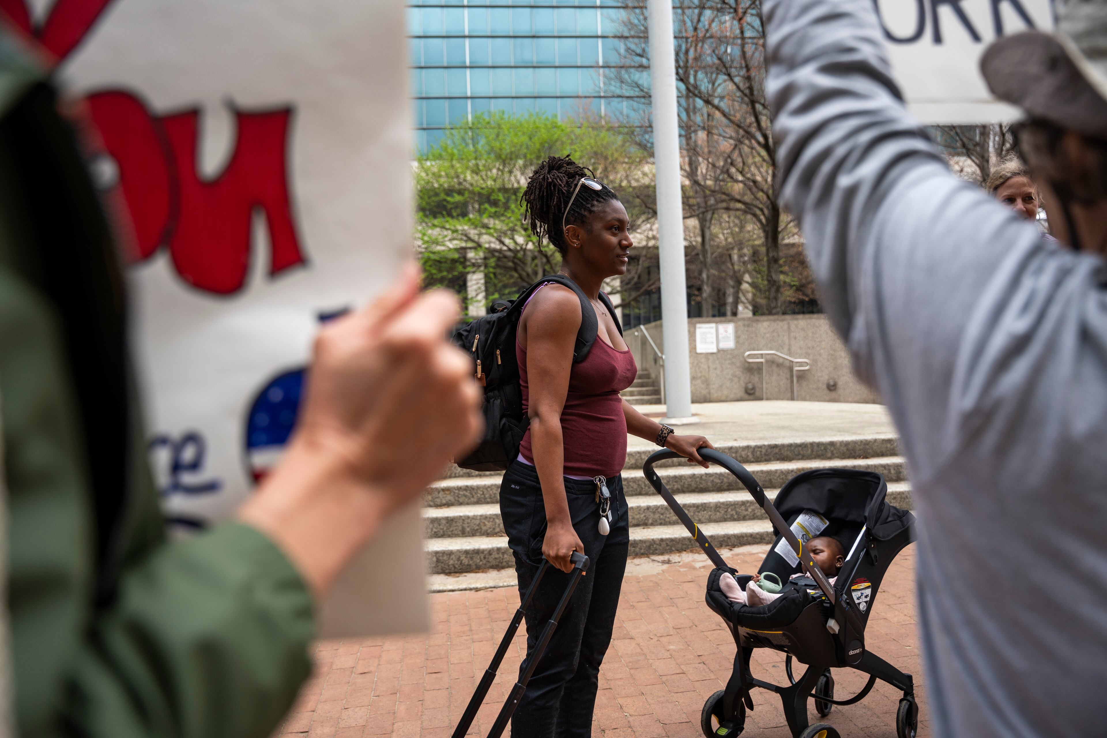 Former U.S. Department of Education employee Tristine Okonye arrives with her baby to pick up her belongings after the Trump administration reduced the department's workforce by roughly 50%. Okonye worked for the Student Financial Aid division. (Olivia Bowdoin for the AJC).
