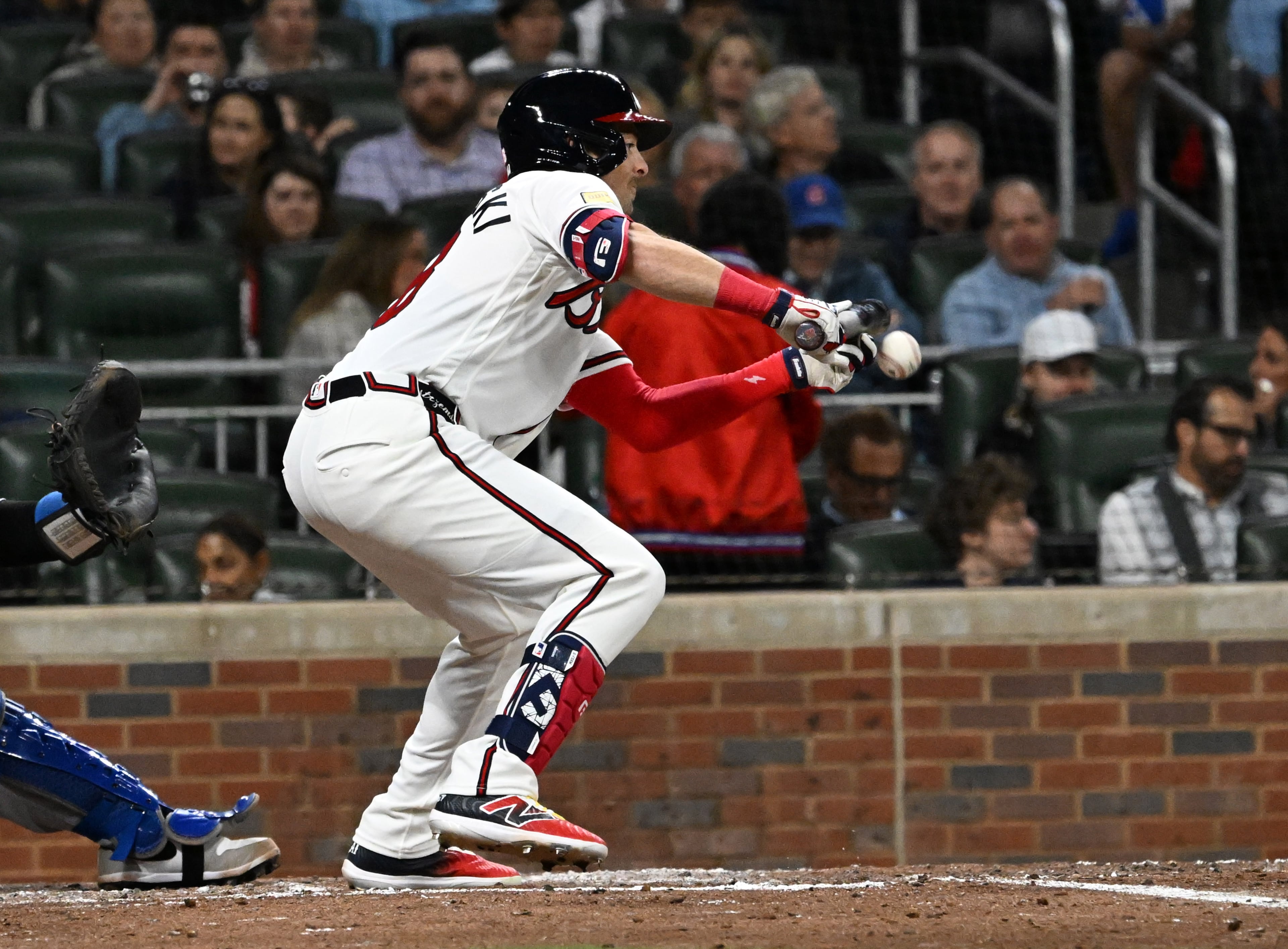 Atlanta Braves right fielder Mike Yastrzemski (18) hits a bunt during the fifth inning of a baseball game at Truist Park, Saturday, March 28, 2026, in Atlanta. Atlanta Braves Dominic Smith hit a grand slam during the 9th inning to win 6-2 over Kansas City Royals. (Hyosub Shin/AJC)