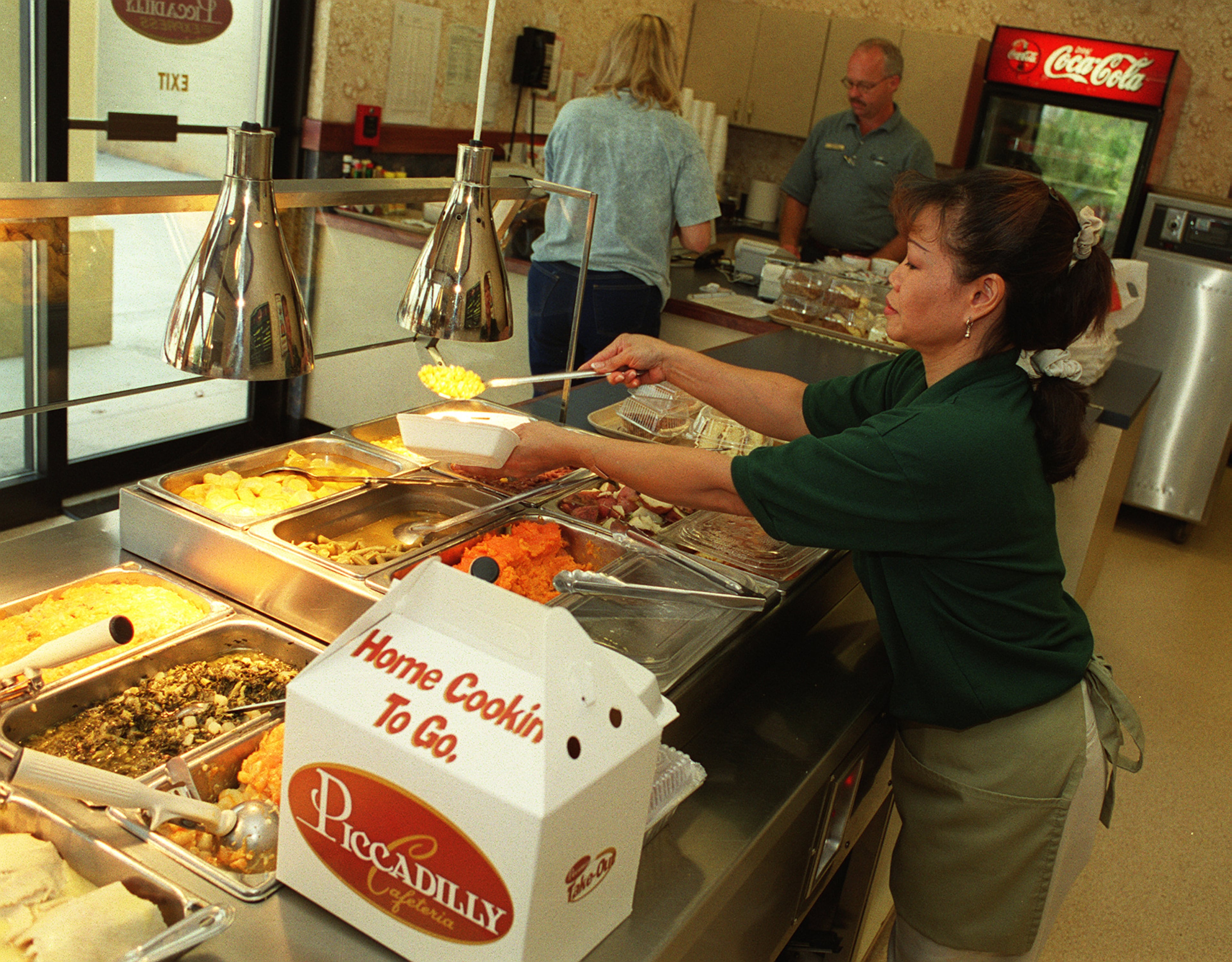 Seewan Cain prepares meals in thee Piccadilly Express section of the Marietta location in this file photo.