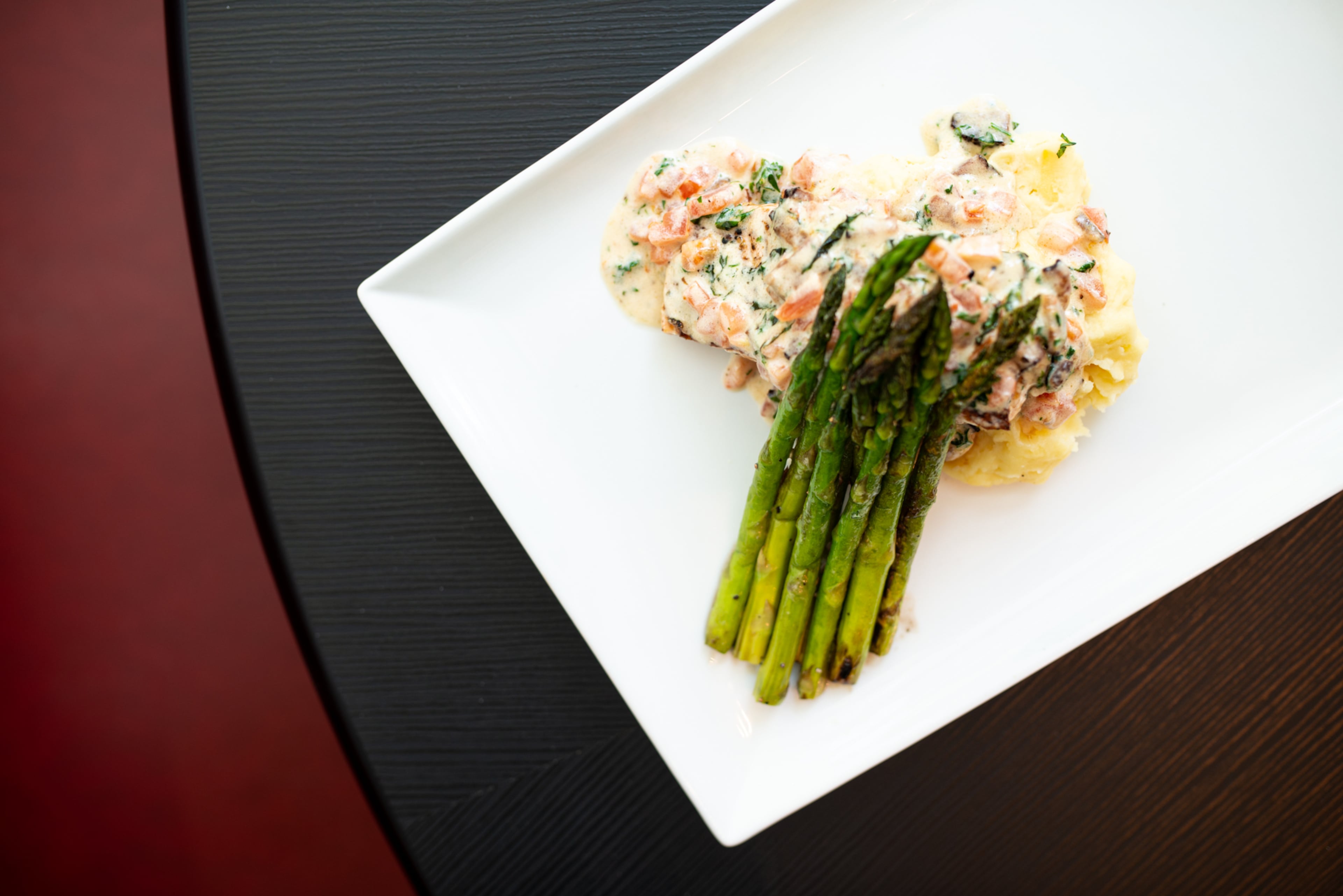 The Sugar Factory Pan Roasted Ora King Salmon, a slow roasted salmon filet, Yukon Gold mashed potatoes, grilled asparagus, and bacon herb sauce.