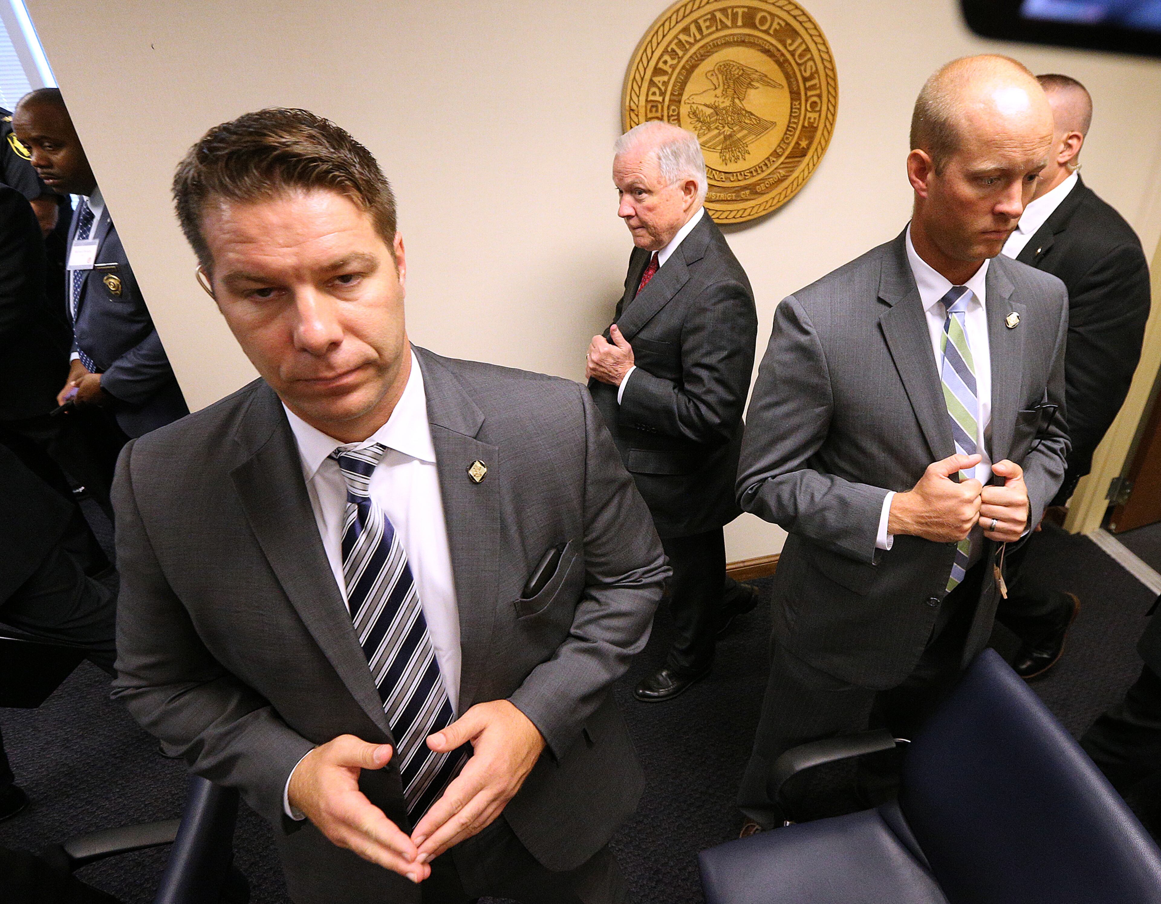 August 9, 2018, Macon: Attorney General Jeff Sessions passes by law enforcement officials as he arrives for his press conference on efforts to combat violent crime at the United Sates Attorney's Office for the Middle District of Georgia on Thursday, August 9, 2018, in Macon. Curtis Compton/ccompton@ajc.com