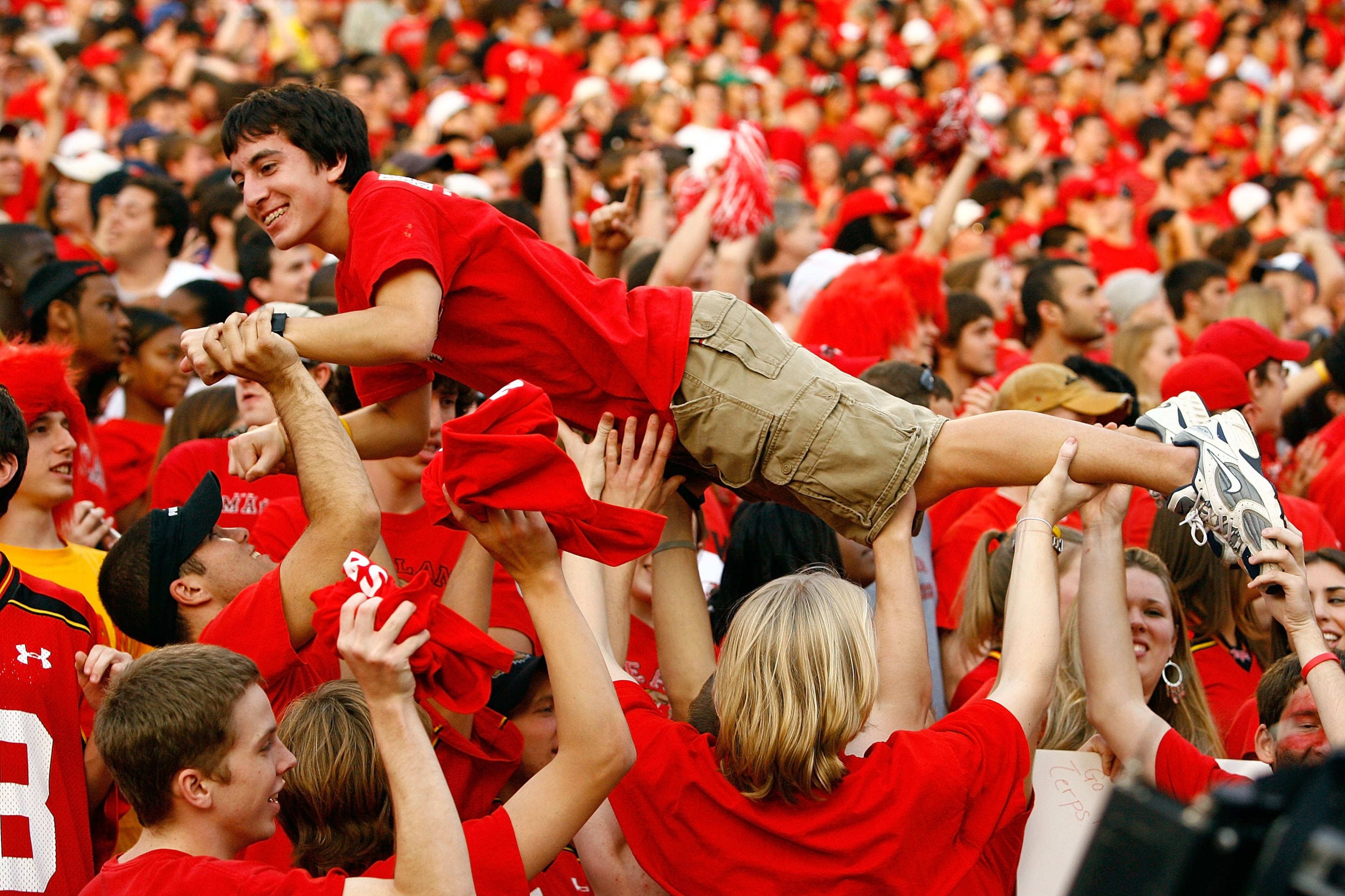 A Maryland Terrapins fan surfs the crowd after the Terrapins scored a touchdown during the game against the Miami Hurricanes at Byrd Stadium on Nov. 11, 2006, in College Park, Md.