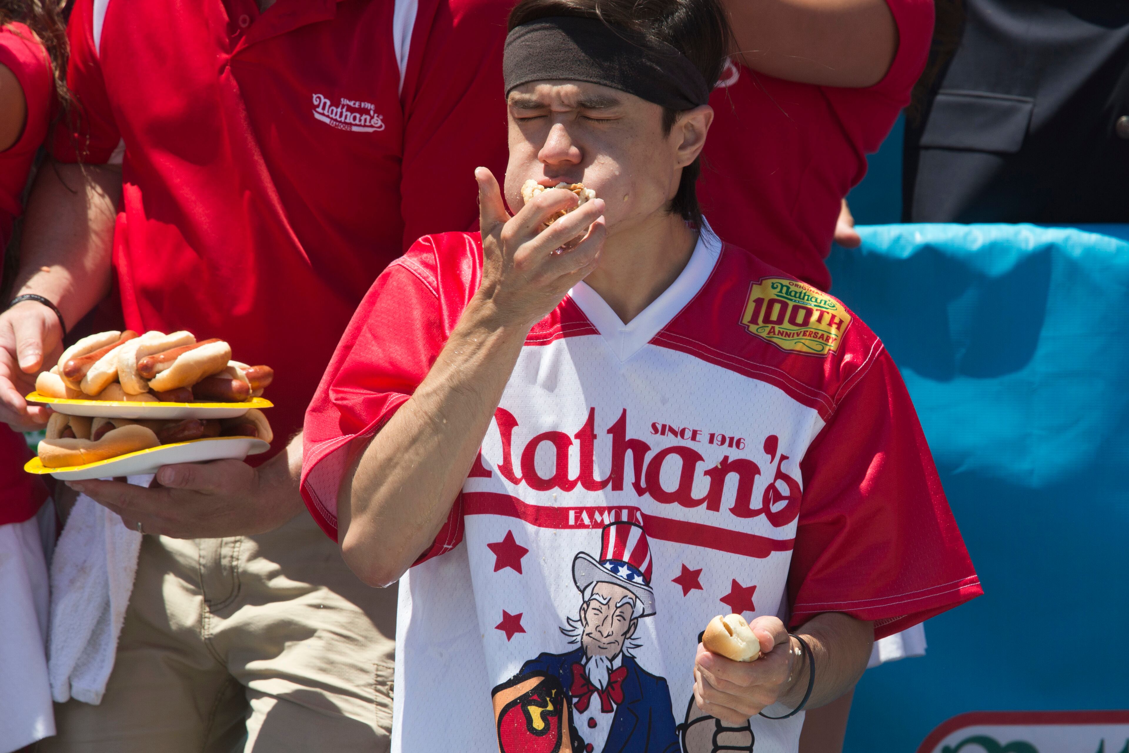 Matt Stonie competes in Nathan's Famous Fourth of July International Hot Dog Eating Contest men's competition, Monday, July 4, 2016, in New York. Stonie came in second eating 53 hot dogs and buns in 10 minutes. (AP Photo/Mary Altaffer)