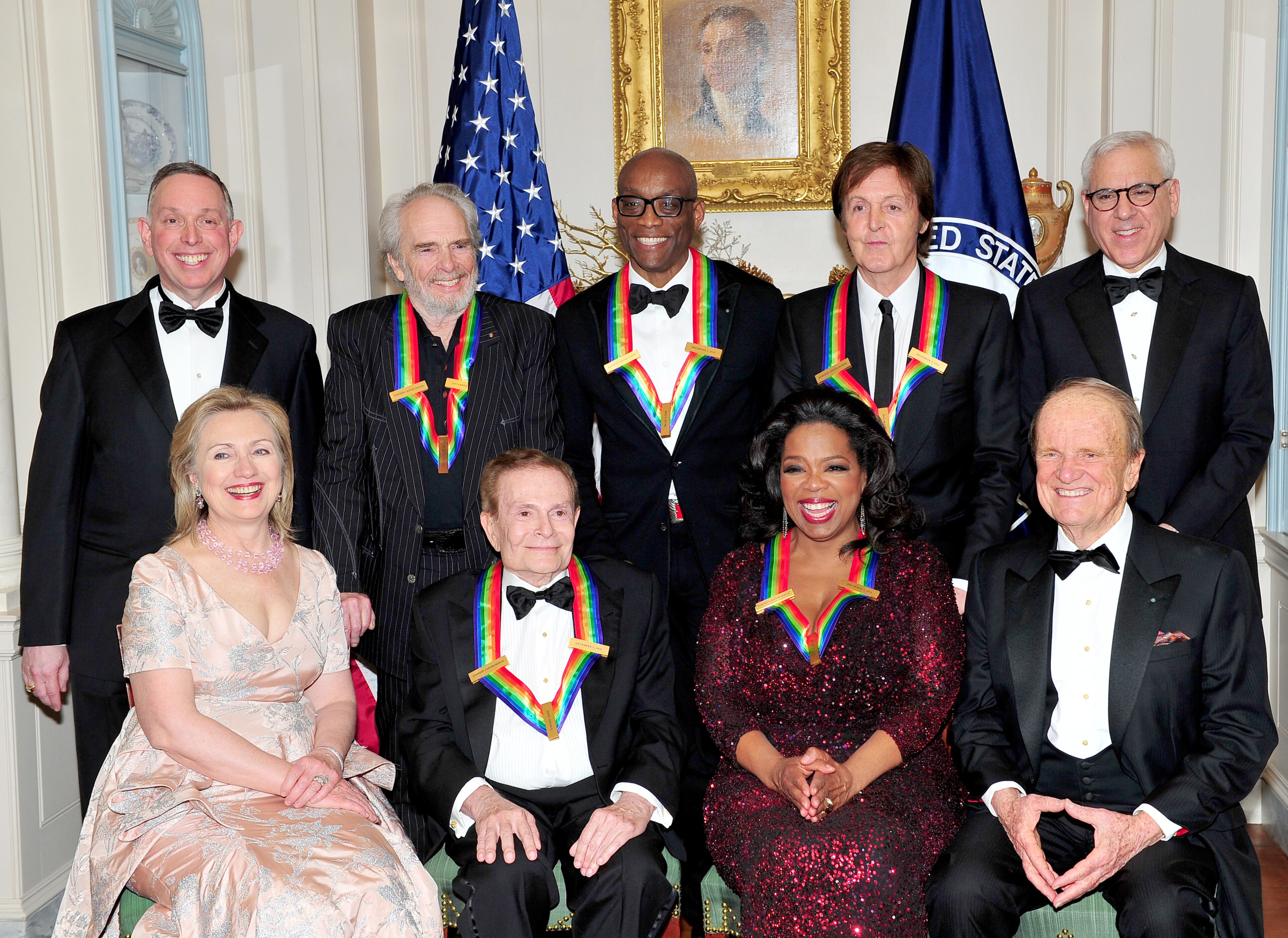 The 2010 Kennedy Center honorees pose for their formal class photo following the formal Artist's Dinner at the United States Department of State in Washington, D.C. on December 4, 2010. Top row, from left to right: Michael M. Kaiser, President, John F. Kennedy Center for the Performing Arts; Merle Haggard; Bill T. Jones; Sir Paul McCartney; and David M. Rubenstein, Chairman, John F. Kennedy Center for the Performing Arts. Bottom row, from left to right: United States Secretary of State Hillary Rodham Clinton; Jerry Herman; Oprah Winfrey; and George Stevens, Jr., creator of "The Kennedy Center Honors". (Photo by Ron Sachs-Pool/Getty Images)