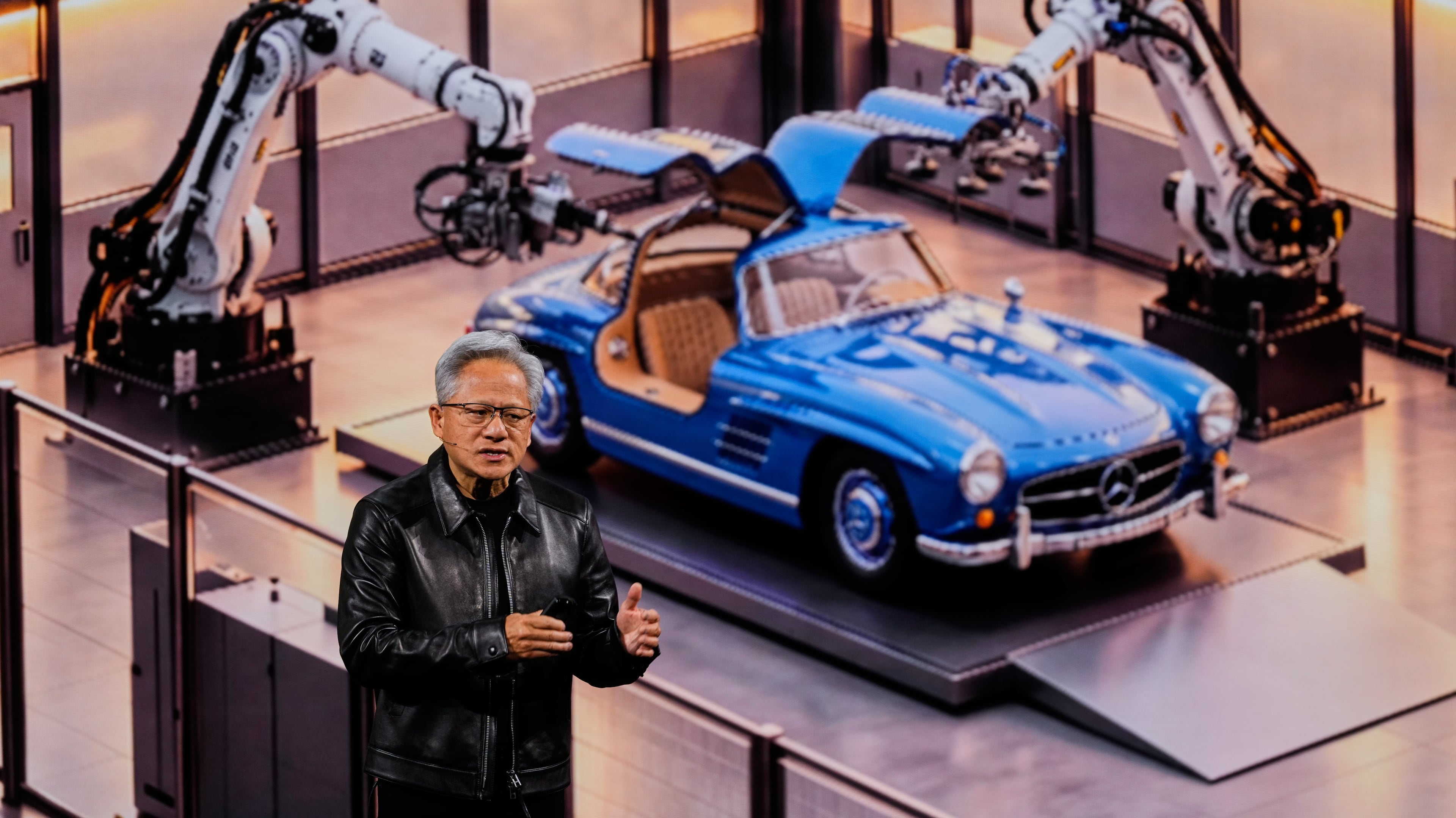 Nvidia CEO Jensen Huang stands near a Mercedes car as he delivers his keynote on the company's GTC event in Berlin, Germany, Wednesday, Oct. 21, 2026. (AP Photo/Markus Schreiber)