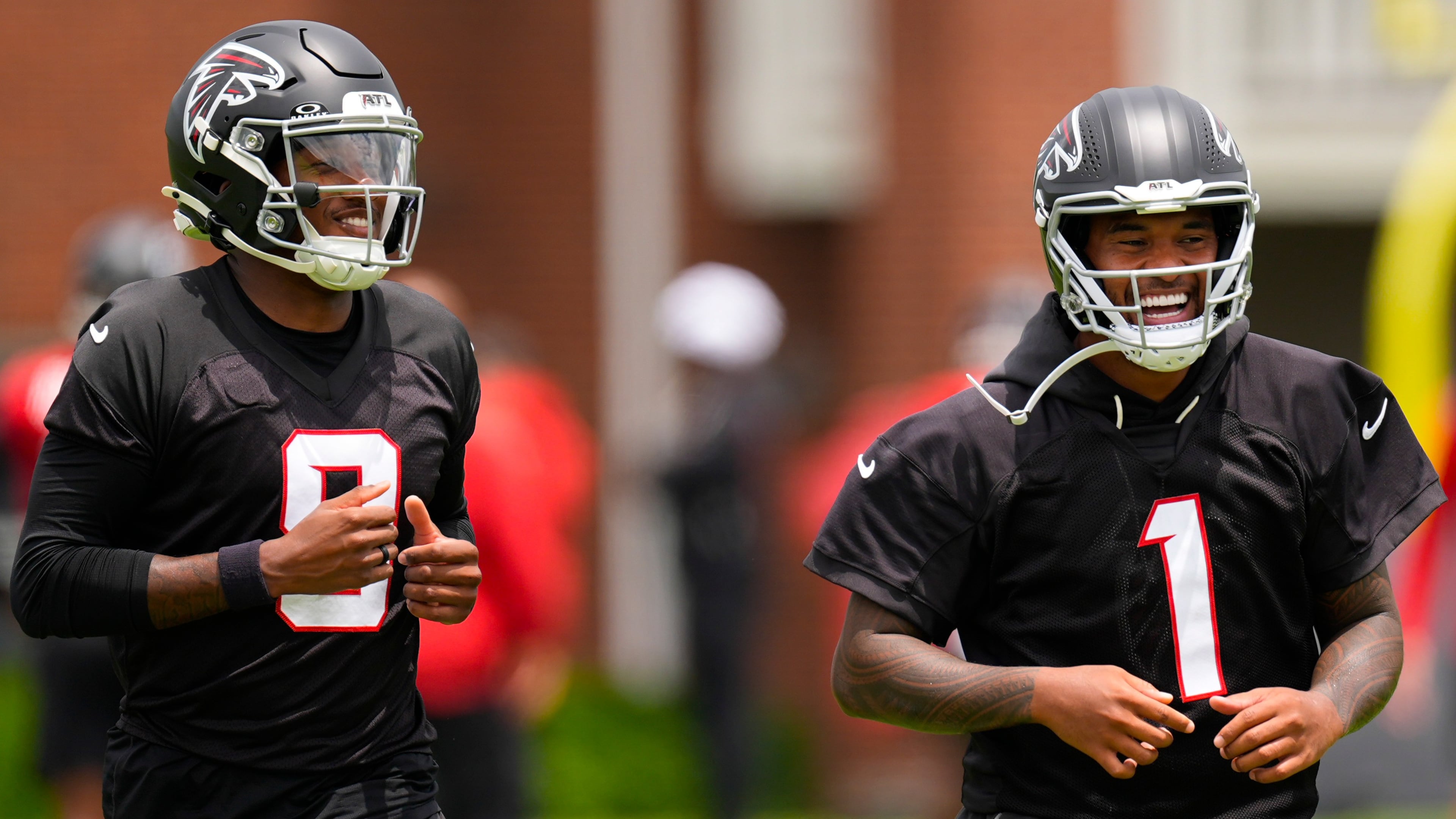 Atlanta Falcons quarterback's Michael Penix Jr. and Tua Tagovailoa (1) move during an NFL football practice, Wednesday, May 27, 2026, in Flowery Branch, Ga. (AP Photo/Mike Stewart)