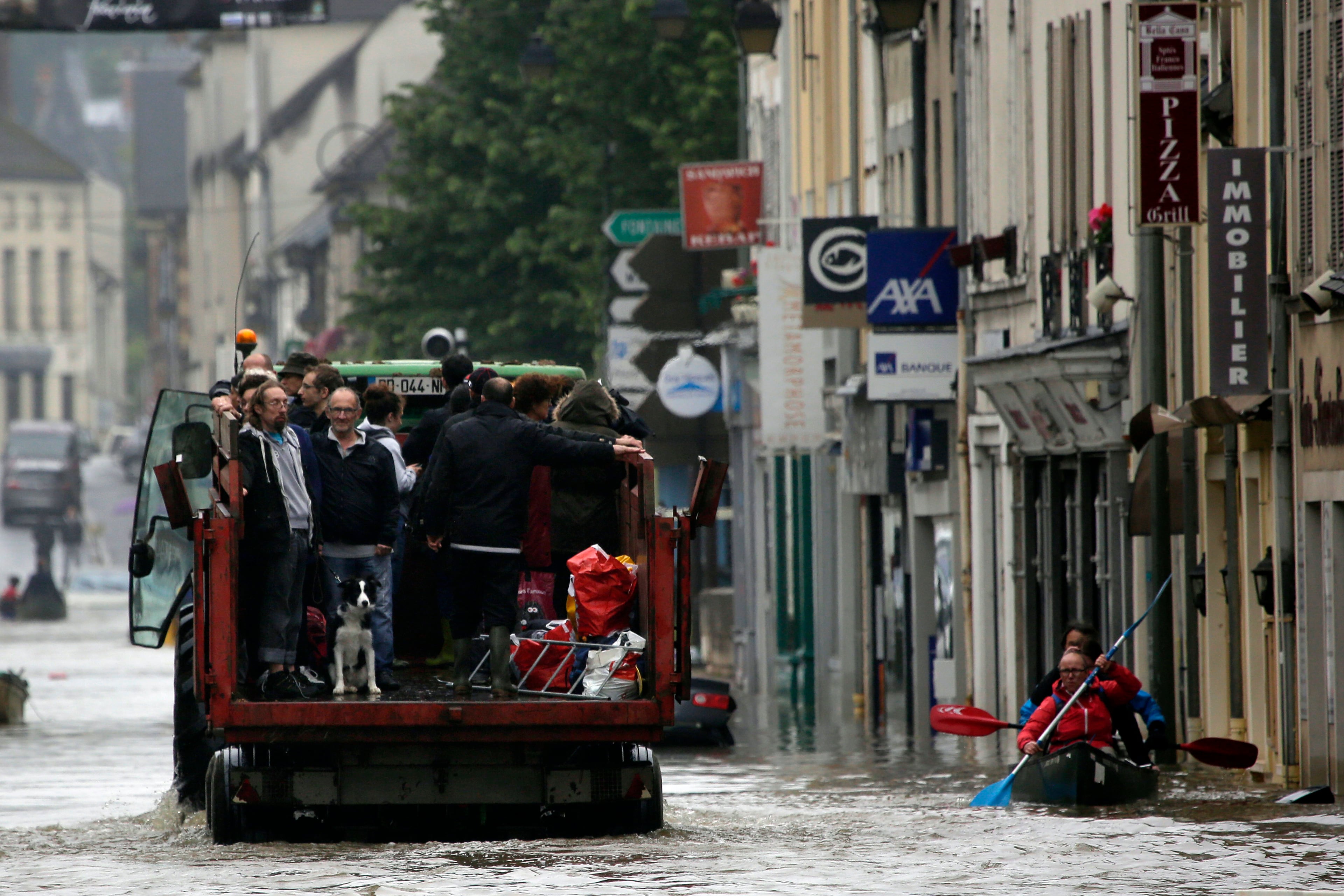 Residents evacuate their home in Nemours, south of Paris, Thursday June 2, 2016. Floods inundating parts of France and Germany have left five people dead and thousands trapped in homes or cars, as rivers have broken their banks from Paris to Bavaria.(AP Photo/Jerome Delay)