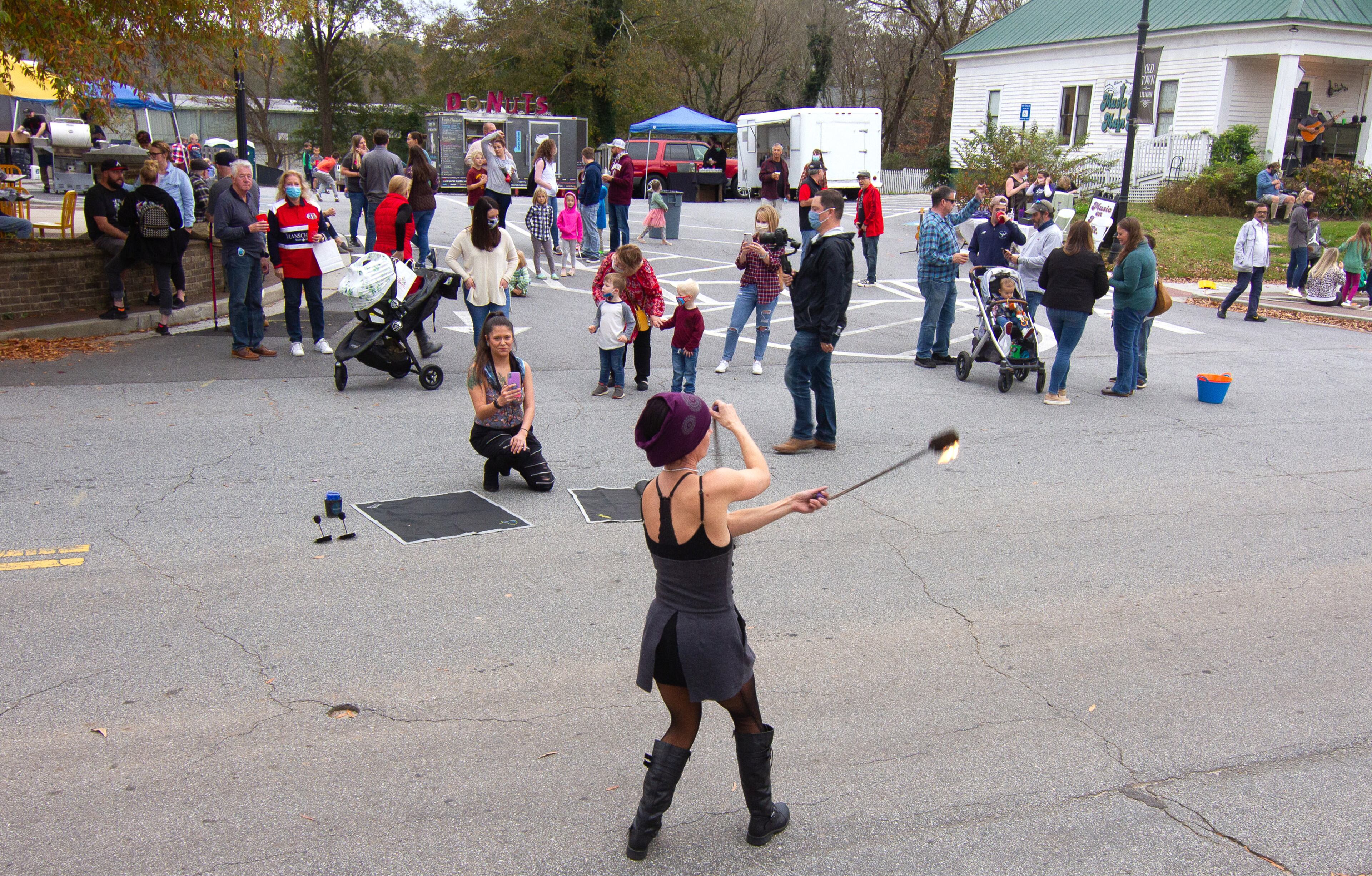 Fire artist Shaina Reeves performs before the start of the bucket brigade reenactment on Sunday, November 15, 2020, to mark the 100th anniversary of when Lilburn was saved from a fire. (Photo: Steve Schaefer for The Atlanta Journal-Constitution)