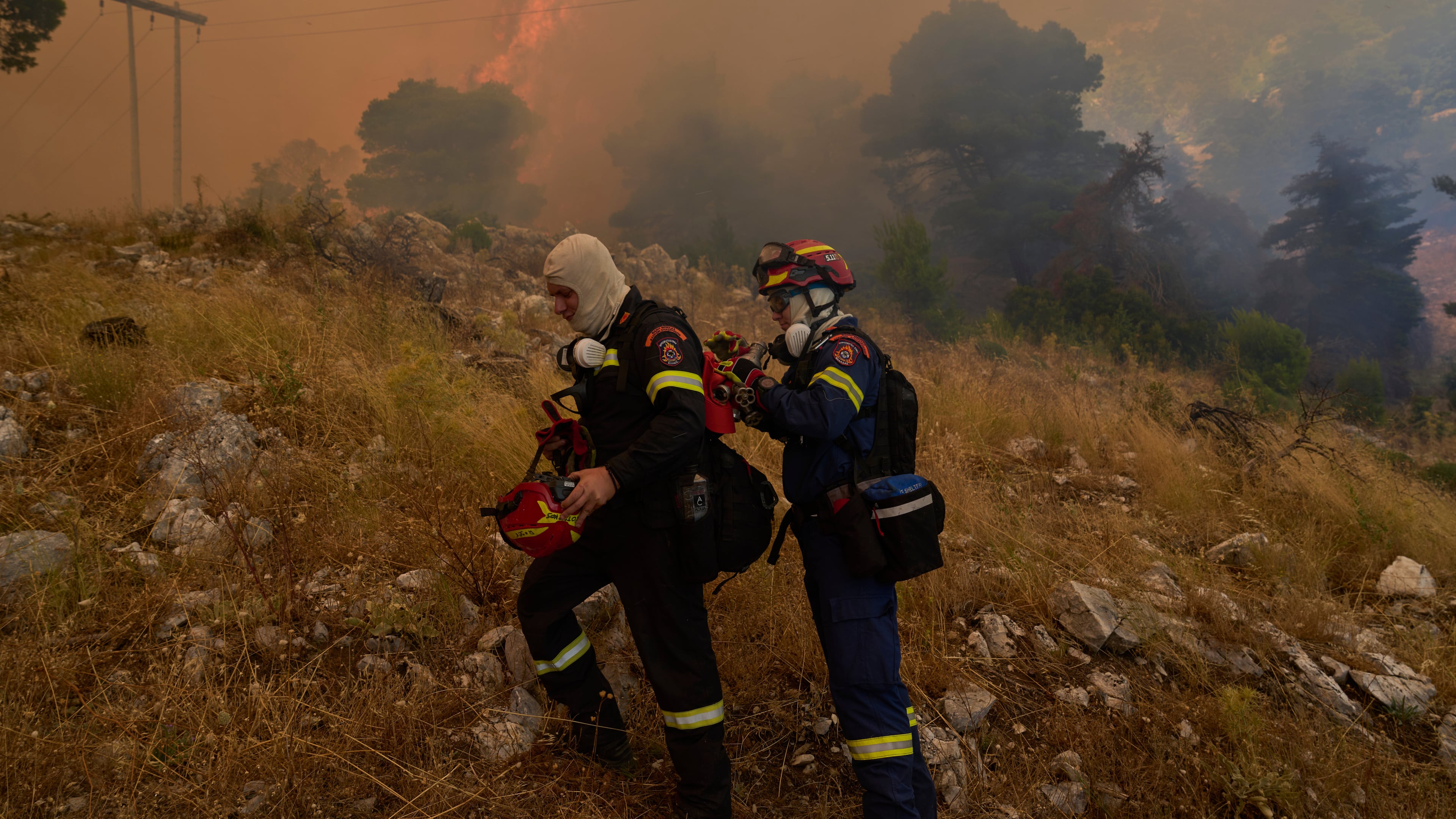 Firefighters operate on Mount Kithairon near Porto Germeno, northwest of Athens, Greece, Monday, Aug. 3, 2026. (AP Photo/Petros Giannakouris)