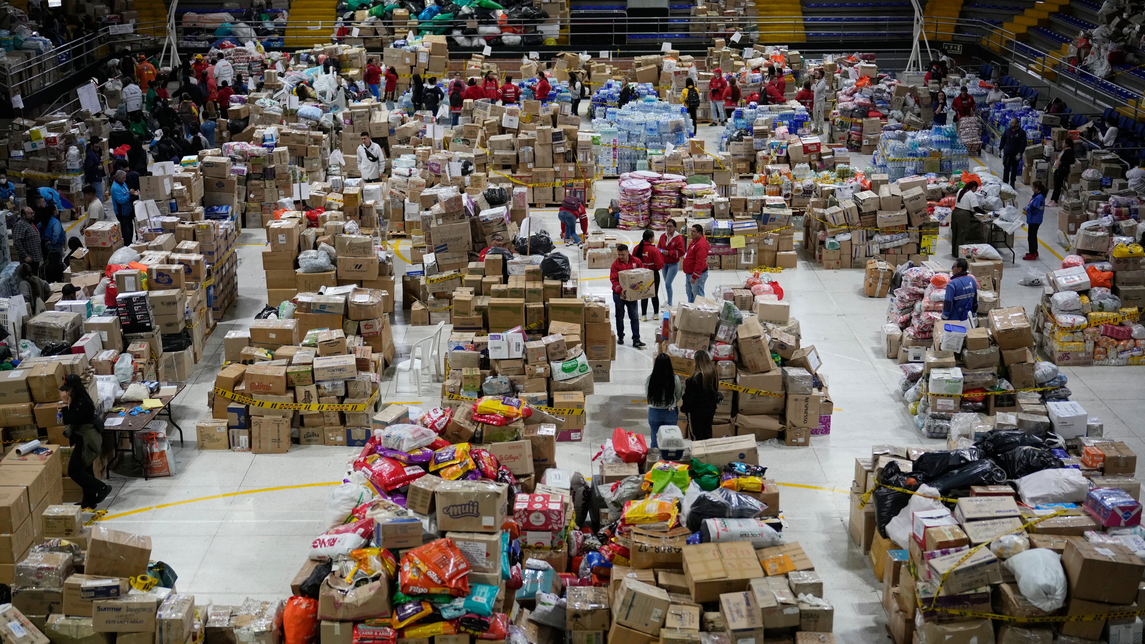 Volunteers sort aid bound for people affected by the earthquake in Choco department, in Bogota, Colombia, Tuesday, Aug. 18, 2026. (AP Photo/Fernando Vergara)