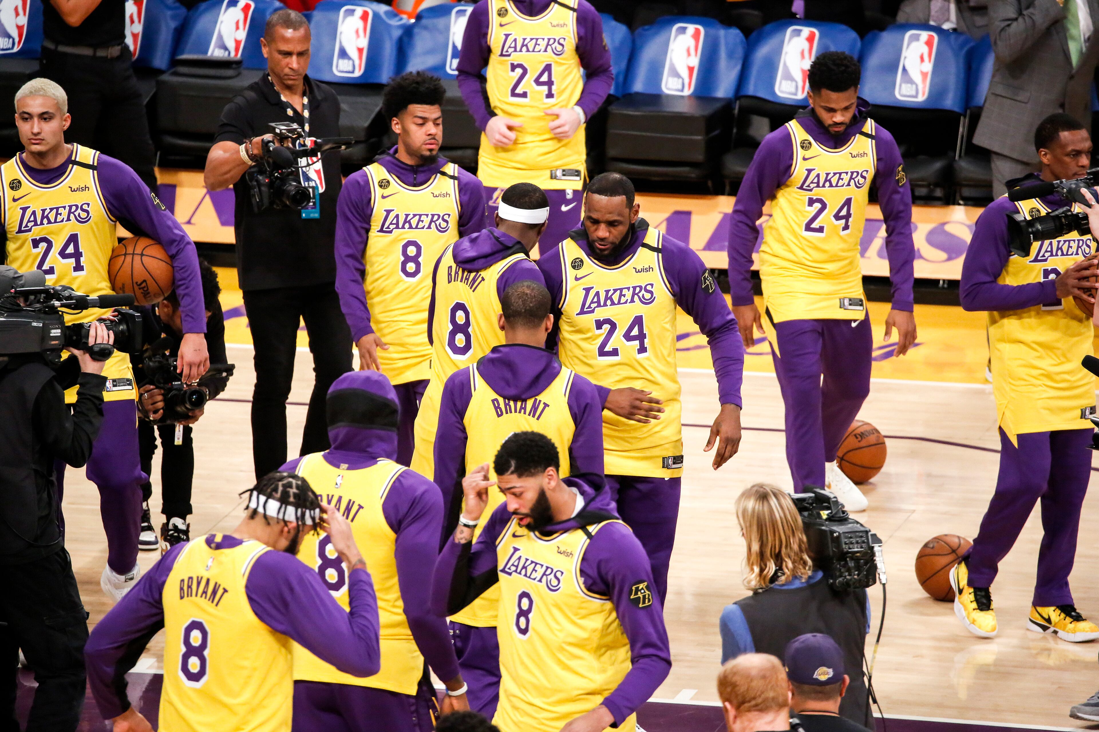 Los Angeles Lakers players wear No. 24 and No.8 jerseys in honor of Kobe Bryant during introductions for the team's NBA game against the Portland Trail Blazers on Friday, Jan. 31, 2020, in Los Angeles. Bryant, the 18-time NBA All-Star who won five championships and became one of the greatest basketball players of his generation during a 20-year career with the Lakers, died in a helicopter crash Sunday. (AP Photo/Ringo H.W. Chiu)