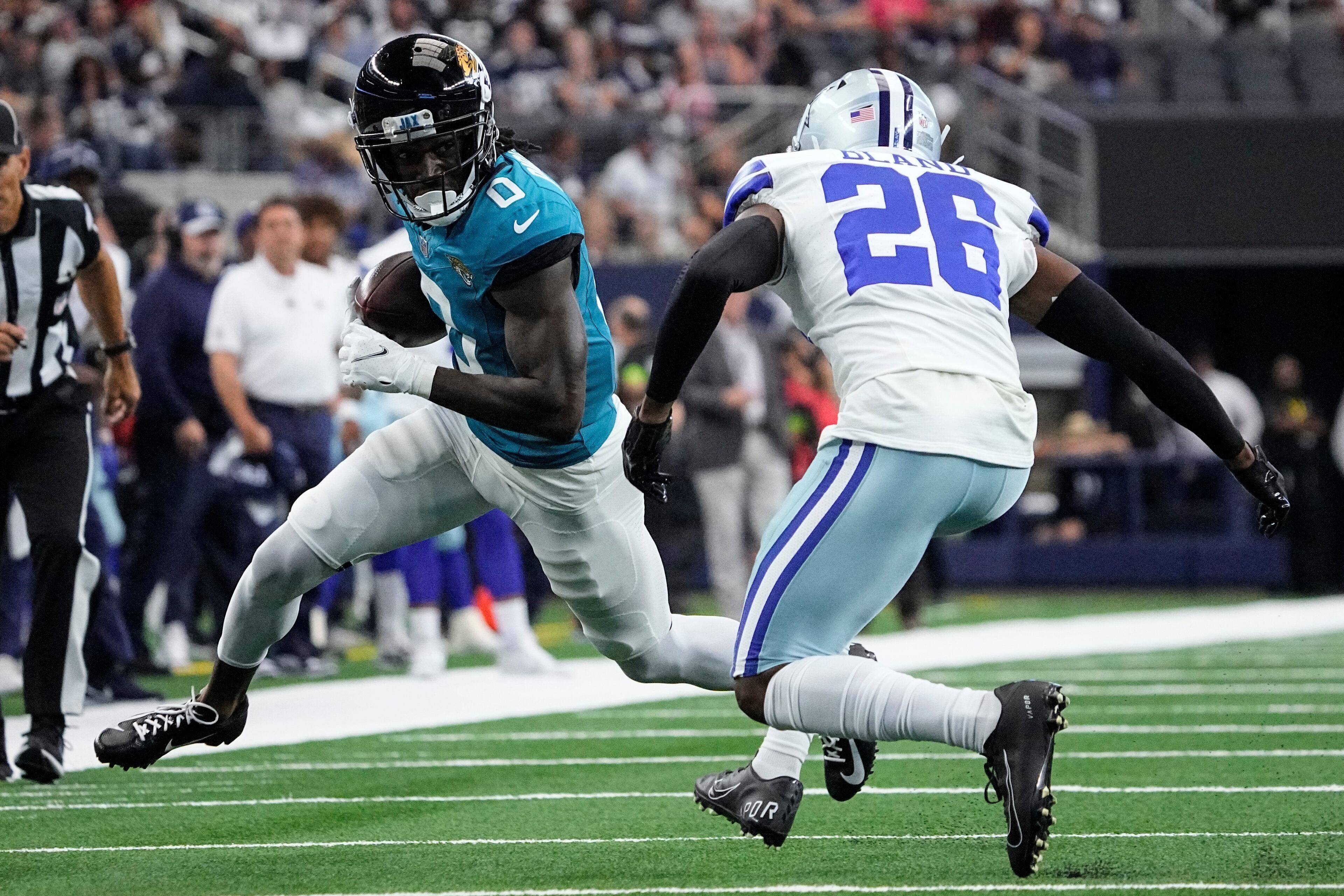 Jacksonville Jaguars wide receiver Calvin Ridley (0), a former Falcons receiver, carries the ball against Dallas Cowboys cornerback DaRon Bland (26) during the first half of an NFL preseason football game, Saturday, Aug. 12, 2023, in Arlington, Texas. (AP Photo/Sam Hodde)