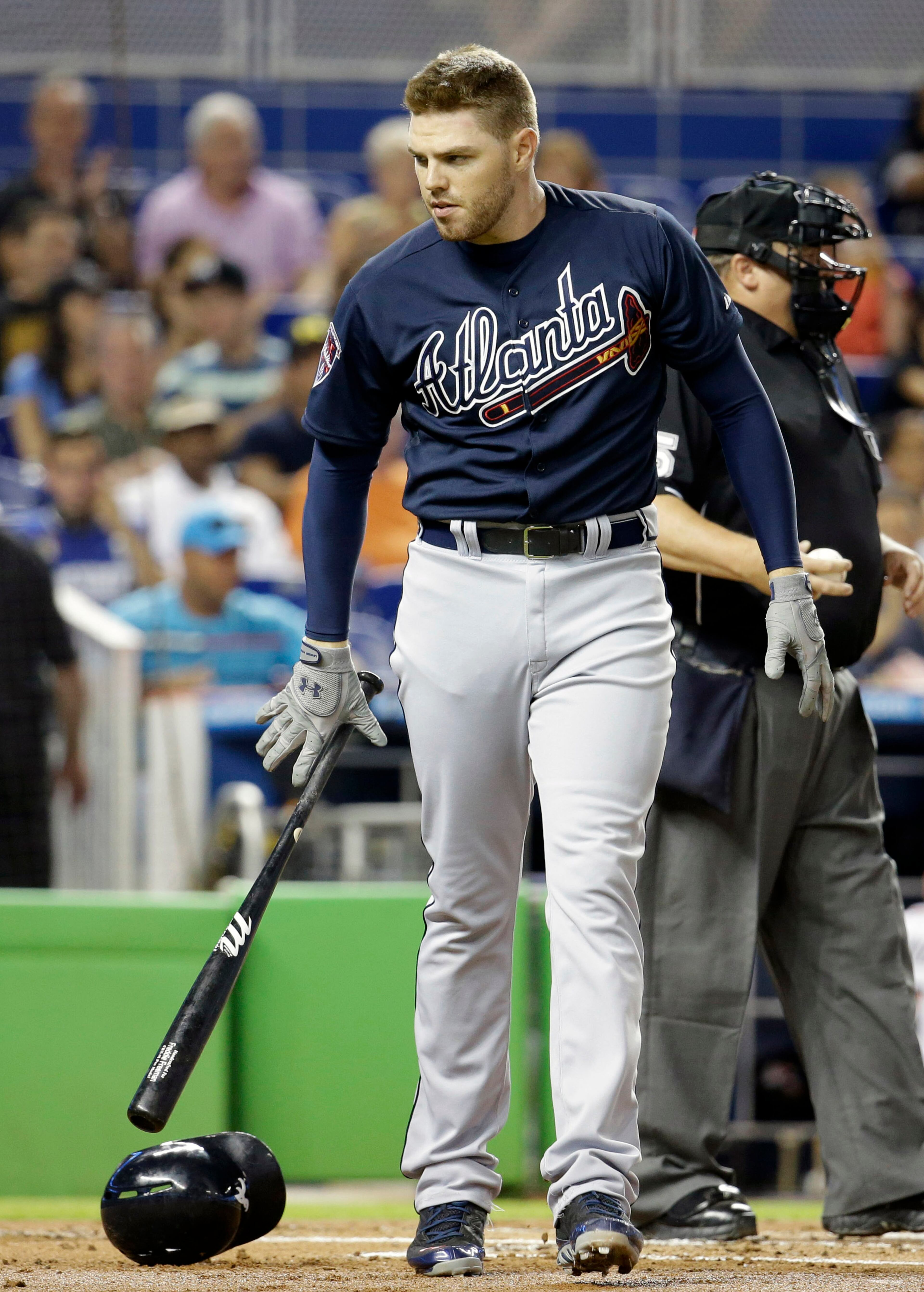 Atlanta Braves' Freddie Freeman drops his bat after striking out in the first inning of a baseball game against the Miami Marlins, Thursday, May 1, 2014, in Miami. (AP Photo/Lynne Sladky)