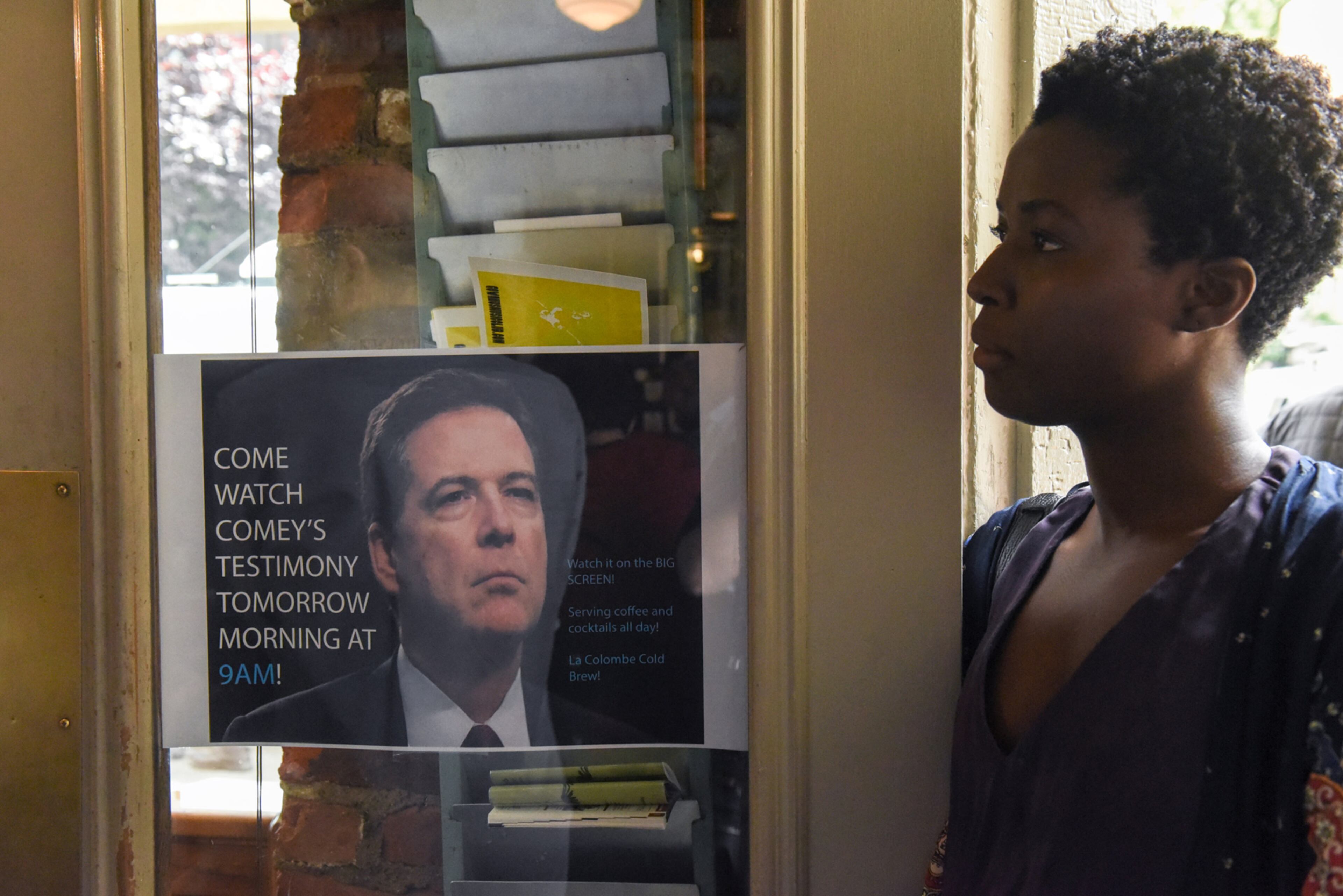 NEW YORK, NY - JUNE 8: A woman watches testimony from former FBI Director James Comey during a Senate Intelligence Committee hearing on Russian interference in the 2016 U.S. election on June 8, 2017 at a restaurant Building on Bond in the Brooklyn borough of New York City. Comey said that President Donald Trump pressured him to drop the FBI's investigation into former National Security Advisor Michael Flynn and demanded Comey's loyalty during the one-on-one meetings he had with president. (Photo by Stephanie Keith/Getty Images)