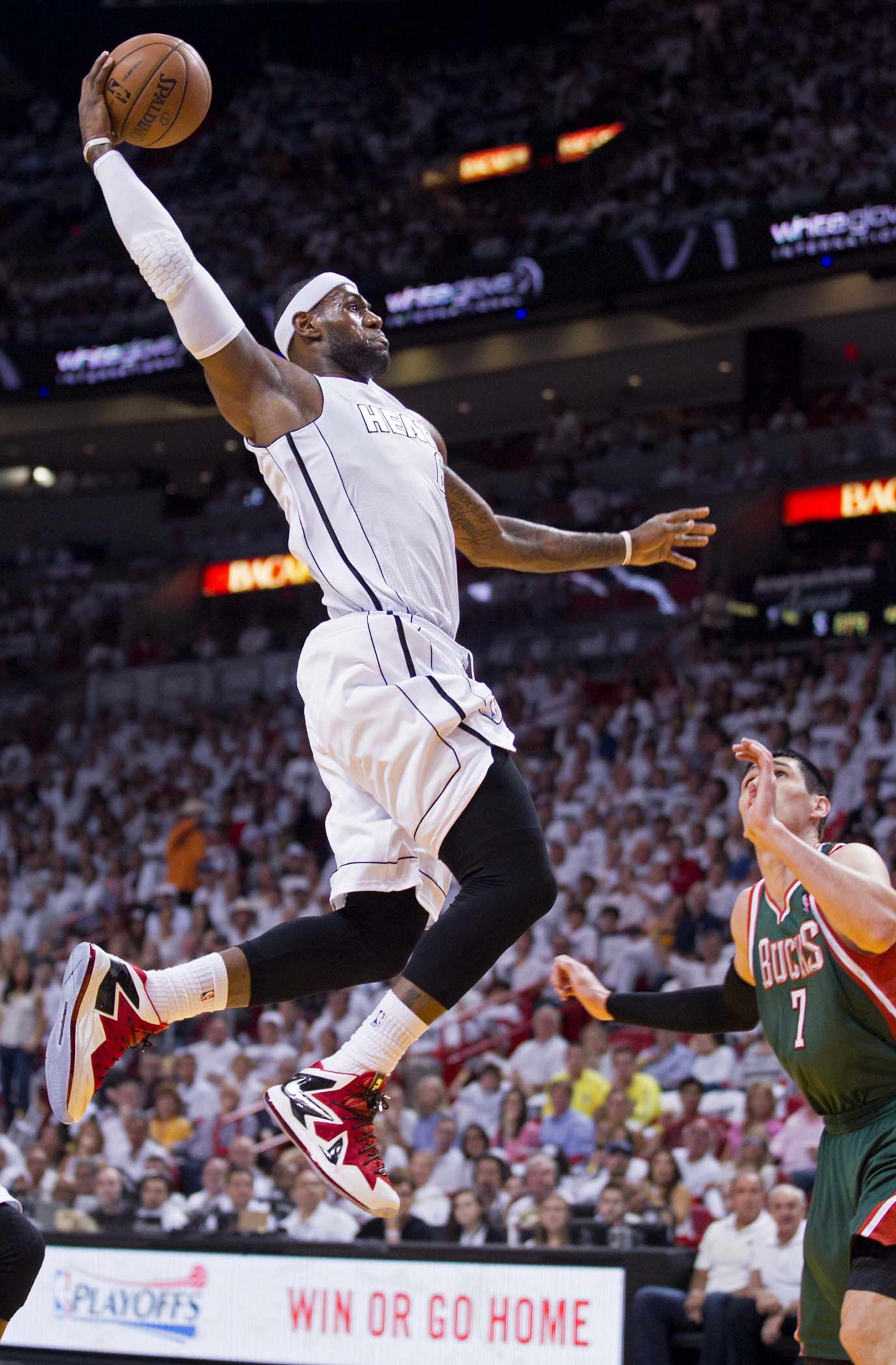 Miami Heat small forward LeBron James (6) dunks over Milwaukee Bucks small forward Ersan Ilyasova (7) at AmericanAirlines Arena on April 21, 2013. (Allen Eyestone/The Palm Beach Post)