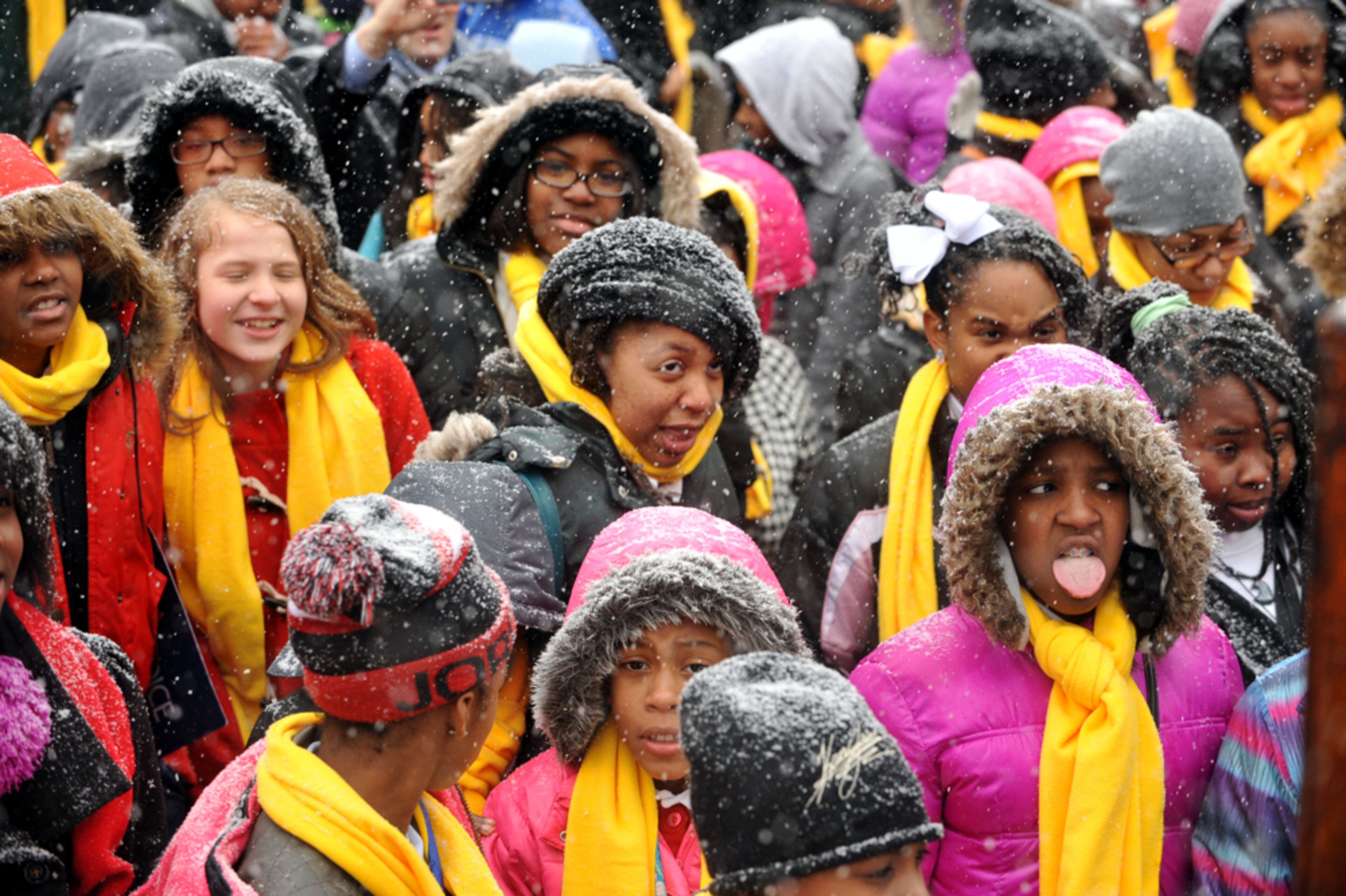 STUDENT RALLY CUT SHORT--JANUARY 28, 2014 ATLANTA Students attending a school choice rally at the Georgia Capitol try to catch snowflakes Tuesday. The rally was cut short due to weather and students were sent home. Snow falling in metro Atlanta caused schools to close early and sent workers home at mid-day, causing gridlock in downtown Atlanta, Tuesday, January 28, 2014. KENT D JOHNSON/KDJOHNSON@AJC.COM