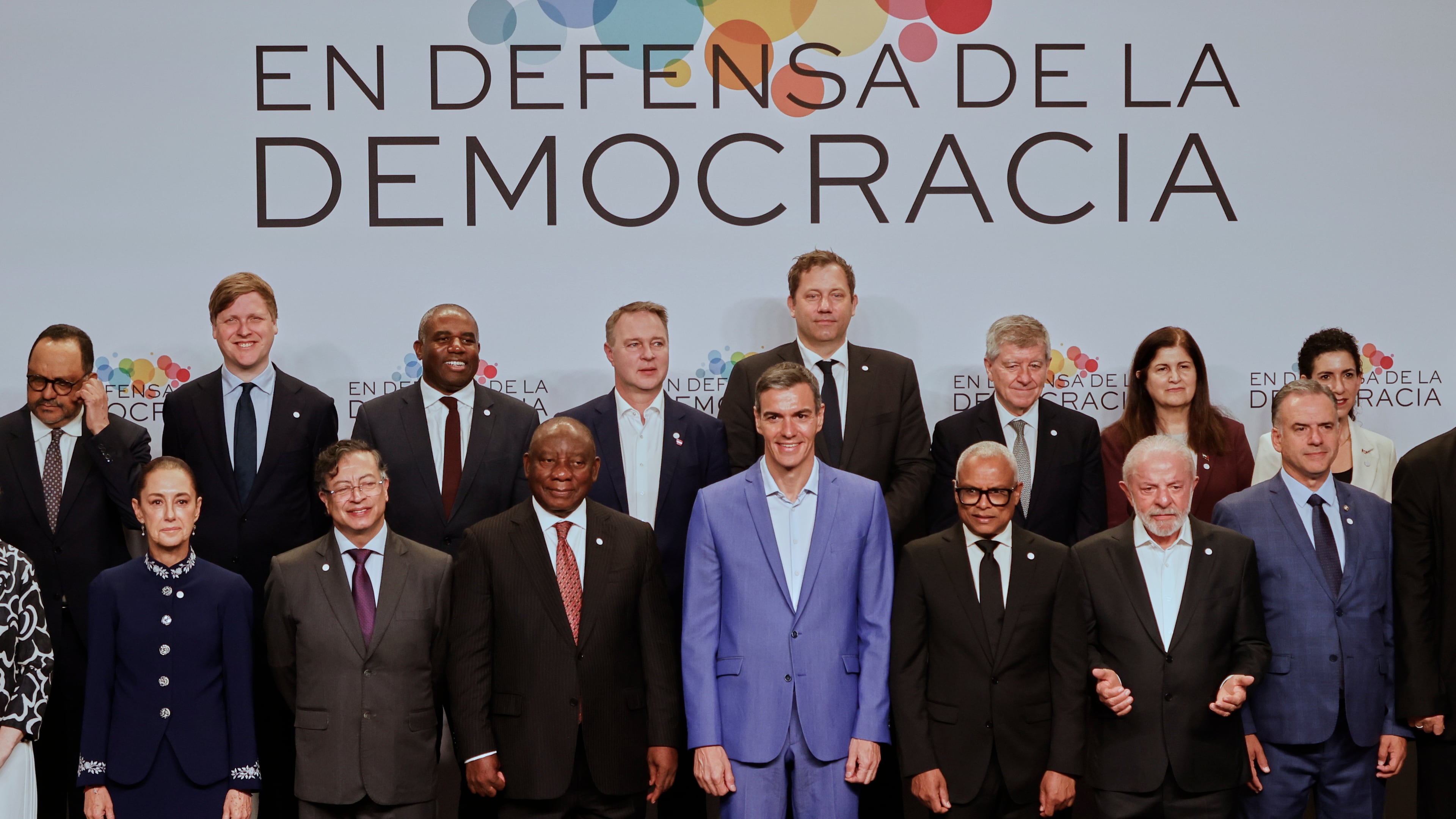 Spain's Prime Minister Pedro Sanchez, center, poses with attendees, at the Meeting in Defence of Democracy summit in Barcelona, Spain, Saturday, April 18, 2026. (AP Photo/Joan Monfort)