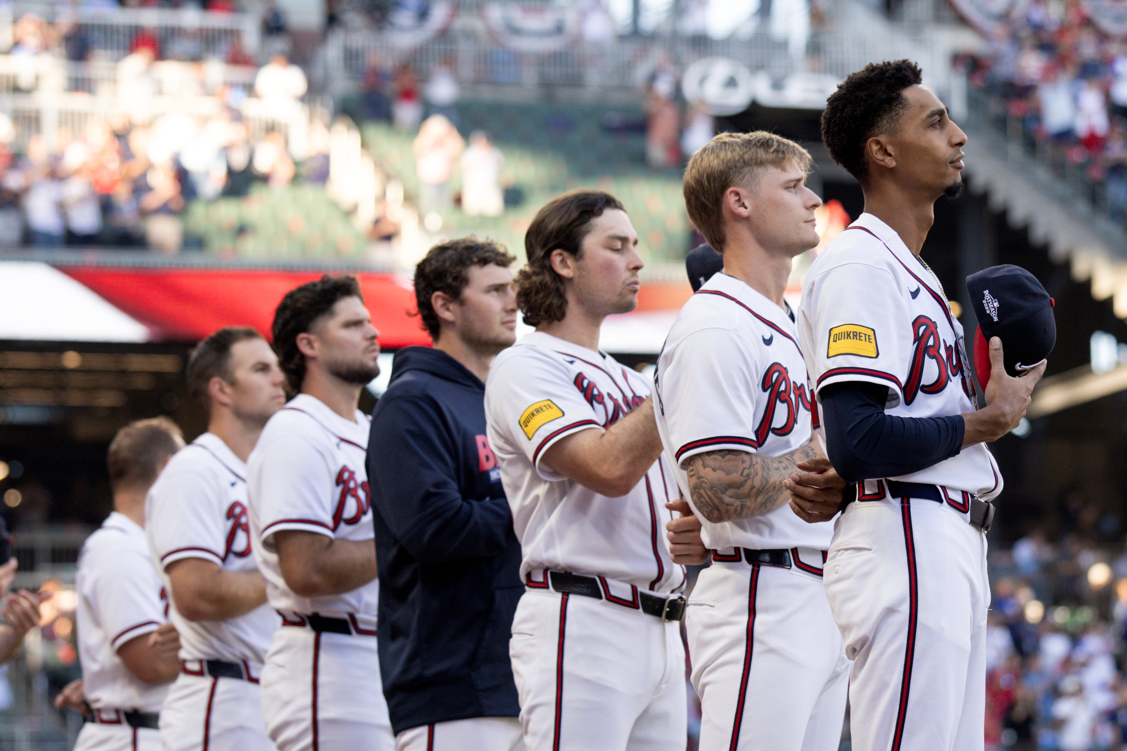 Members of the Atlanta Braves stand for the US national anthem before Game 4 of the MLB National League Division Series between the Atlanta Braves and the Los Angeles Dodgers, Wednesday, Oct. 7, 2026, in Atlanta. (Miguel Martinez/AJC)