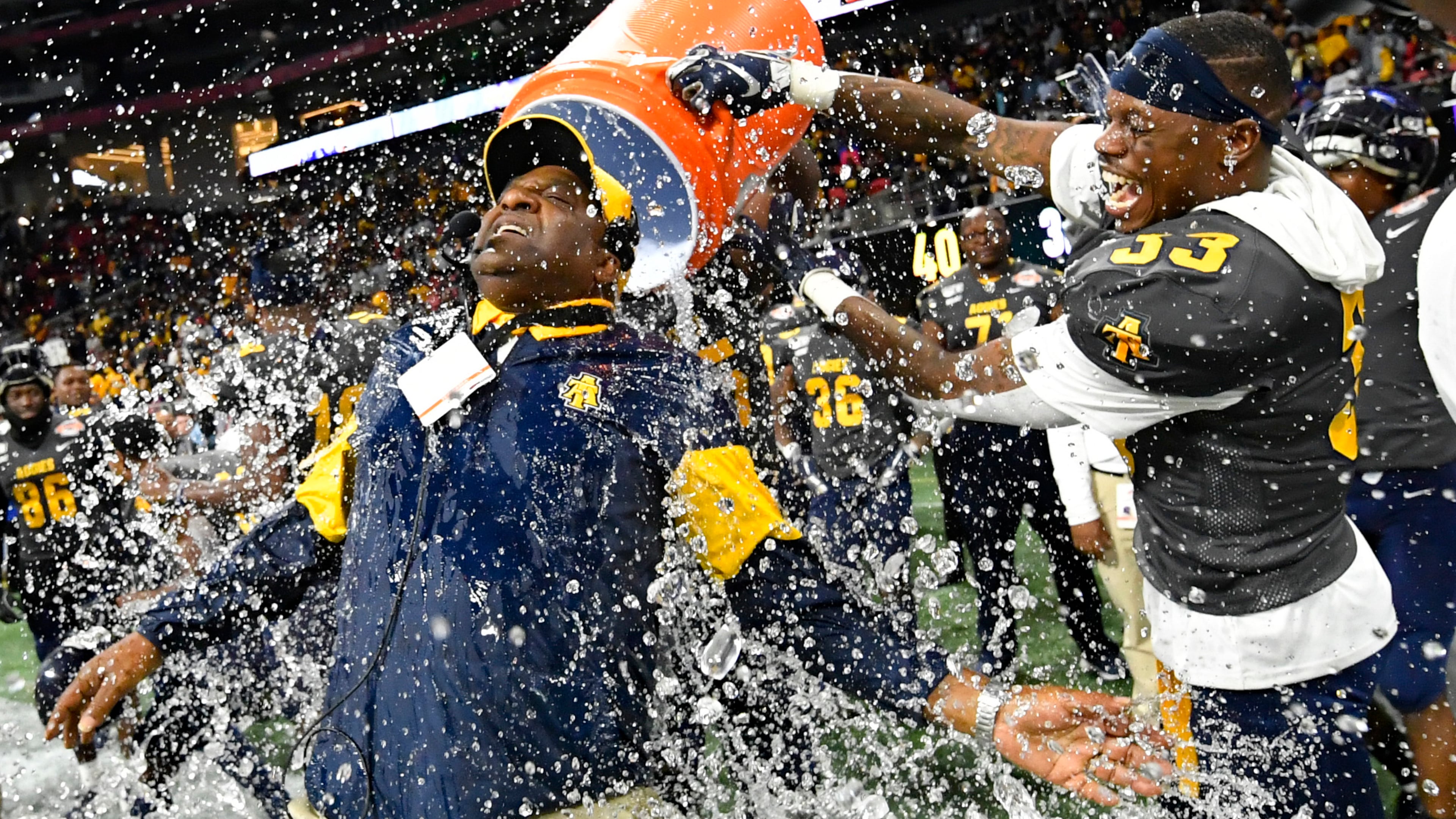 North Carolina A&T coach Sam Washington is doused by defensive back Jalon Bethea during the final seconds of the 64-44 win over Alcorn State in the Celebration Bowl Saturday, Dec. 21, 2019, at Mercedes-Benz Stadium in Atlanta.
