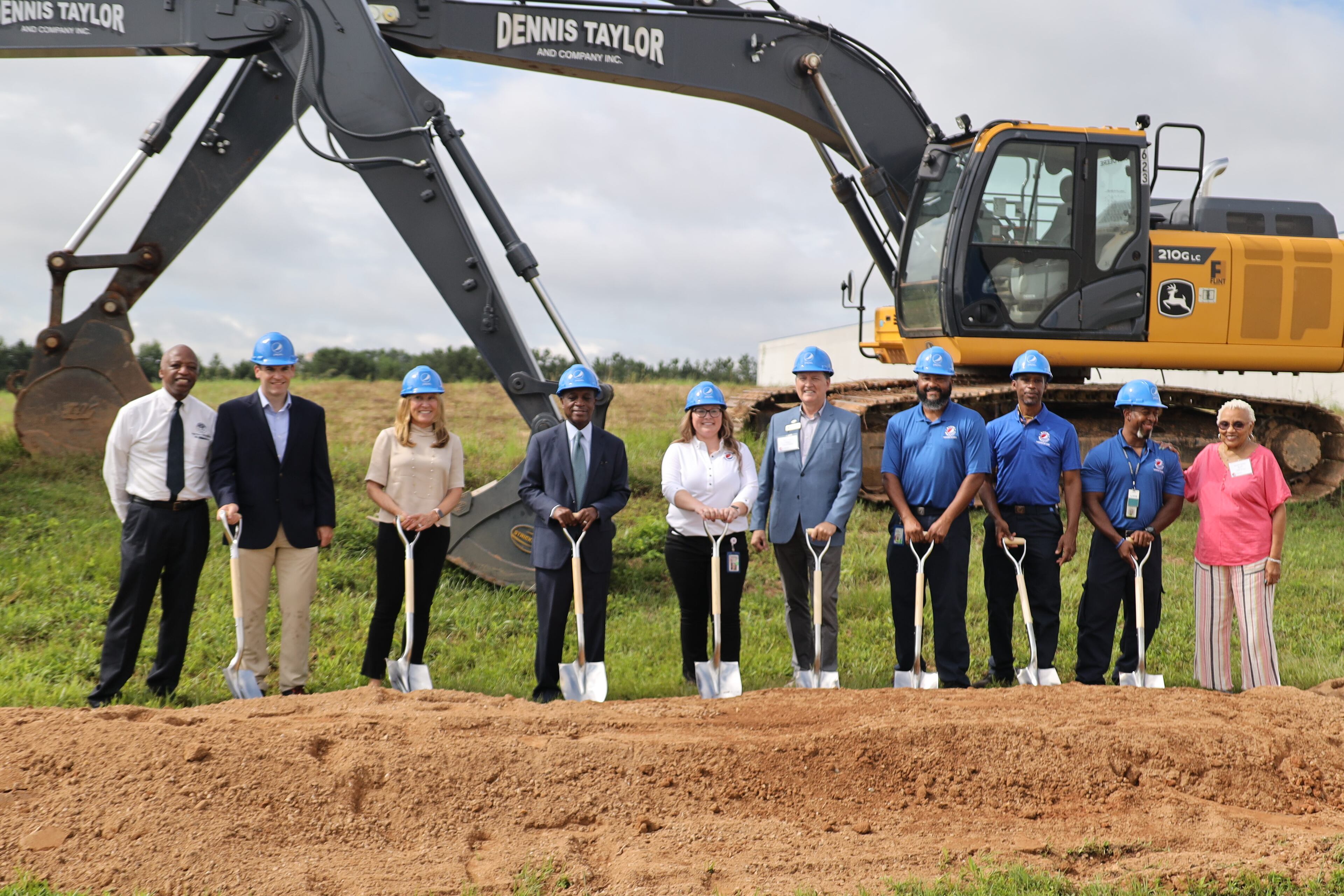 DeKalb County CEO Michael Thurmond (fourth from left) and other officials break ground on an expansion of PepsiCo's bottling plant in Tucker.