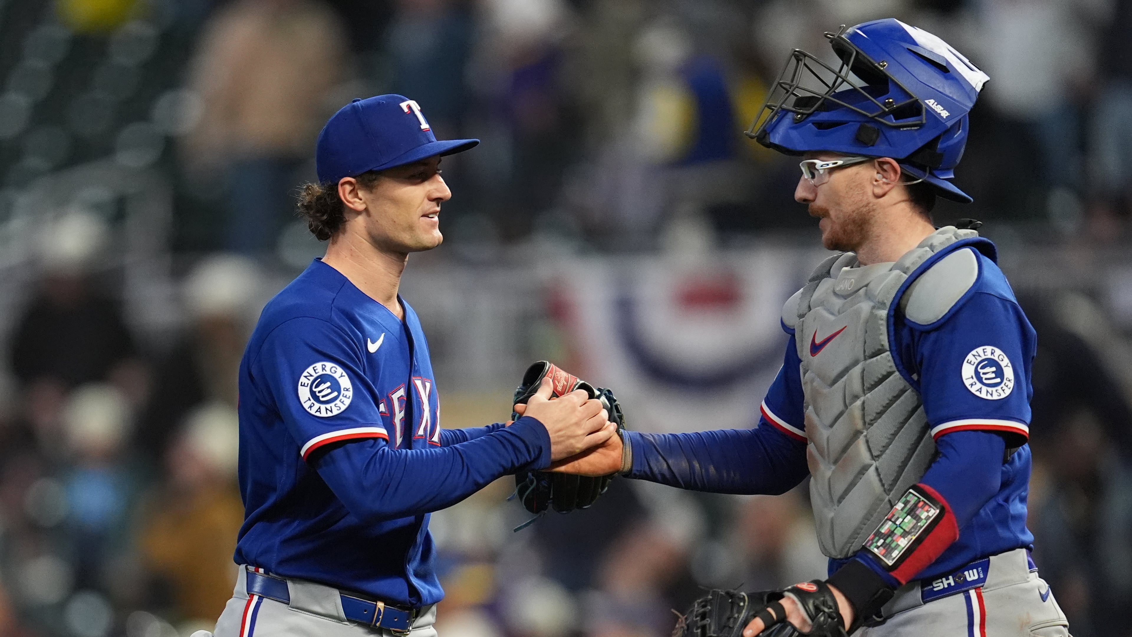 Texas Rangers relief pitcher Jacob Latz, left, and catcher Danny Jansen, right, shake hands after a baseball game against the Minnesota Twins, Saturday, Sept. 26, 2026, in Minneapolis. (AP Photo/Abbie Parr)